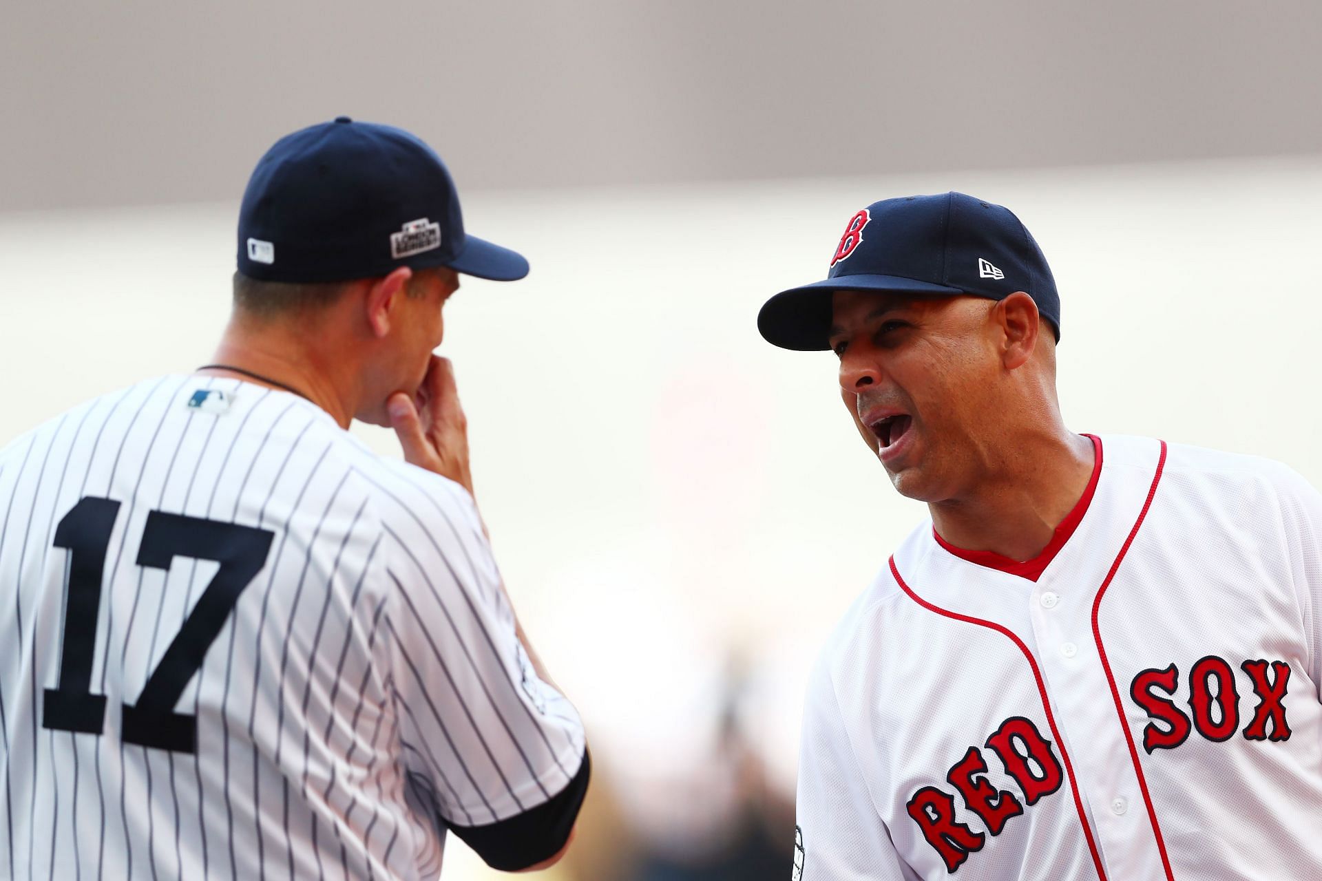 Aaron Boone of the New York Yankees speaks with Alex Cora of the Boston Red Sox before the MLB London Series