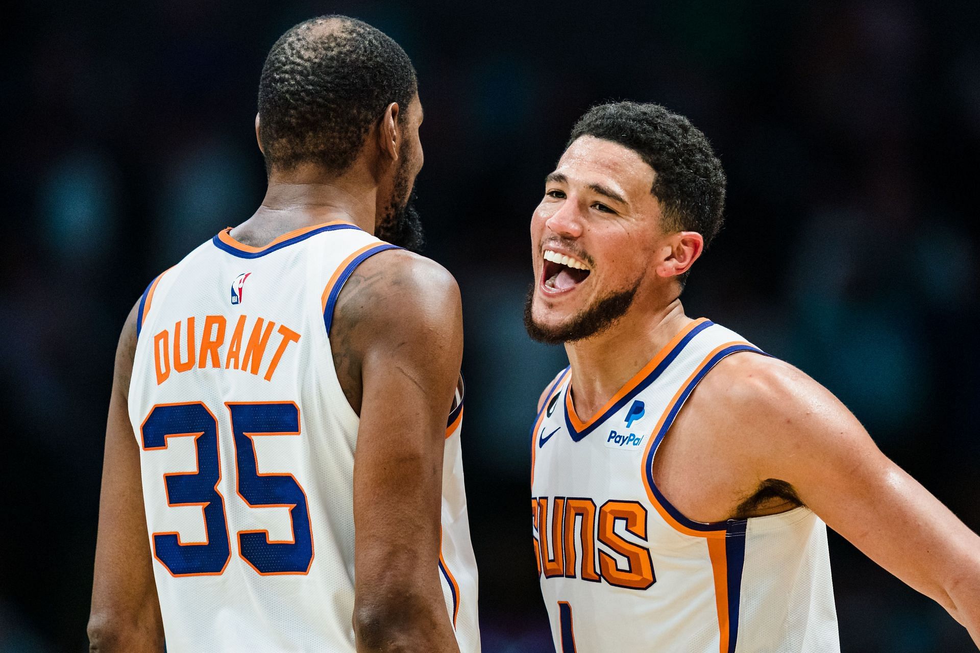 Phoenix Suns duo Kevin Durant and Devin Booker celebrate winning against the Charlotte Hornets