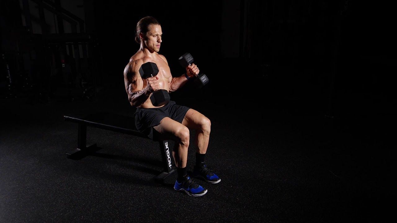 Seated hammer curls help to build bigger and stronger biceps. (image via youtube/functional bodybuilding)