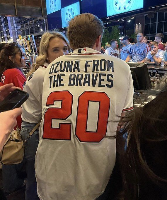 MLB Twitter reacts to fan sporting a customized Marcell Ozuna quote jersey:  I hope this dude ain't driving