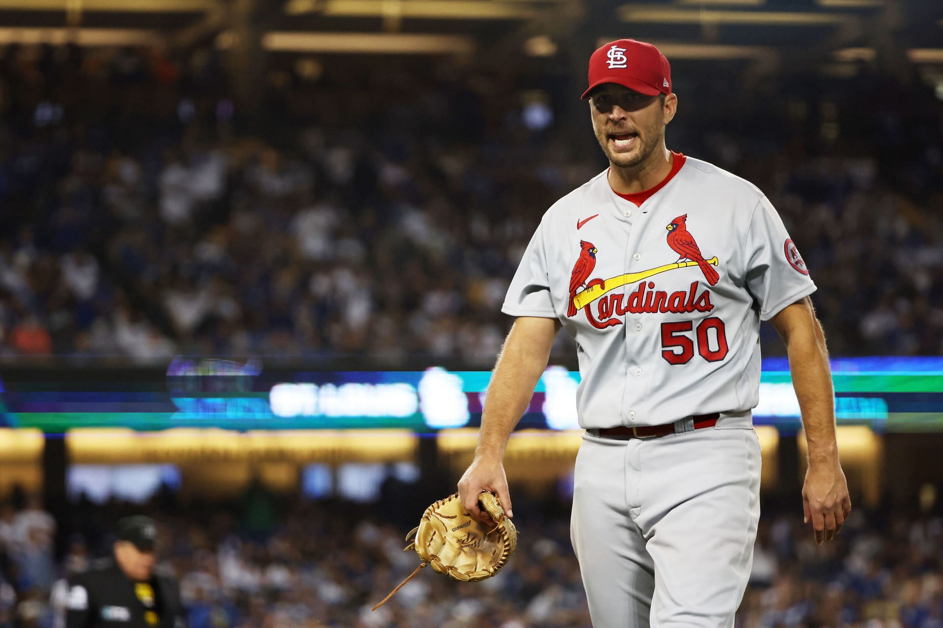 Adam Wainwright #50 of the St. Louis Cardinals walk to the dugout after being pulled from the game in the sixth inning against the Los Angeles Dodgers during the National League Wild Card Game at Dodger Stadium on October 06, 2021 in Los Angeles, California.