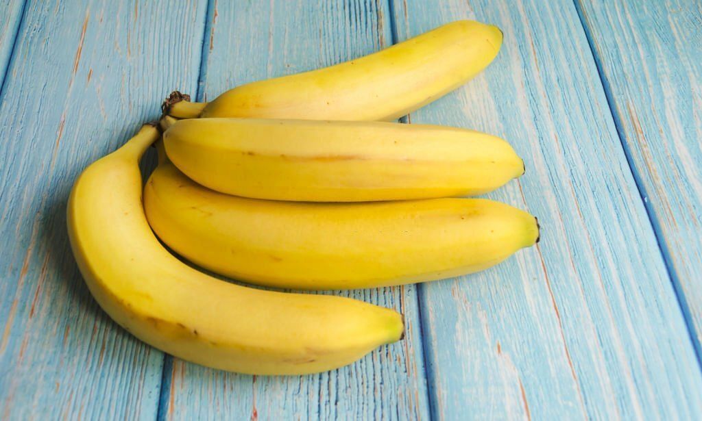 Bananas on blue background(Image via Getty Images)