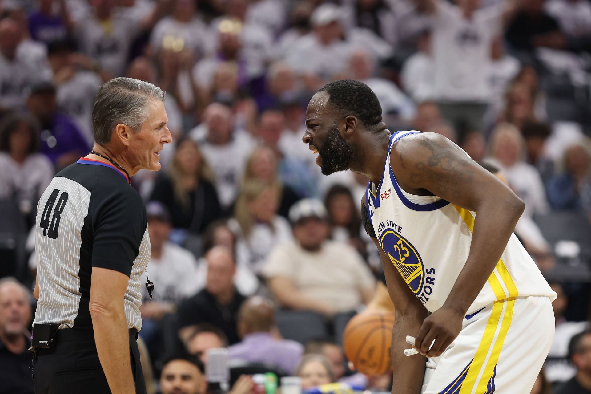 Draymond Green (right) talking to NBA referee Scott Foster.