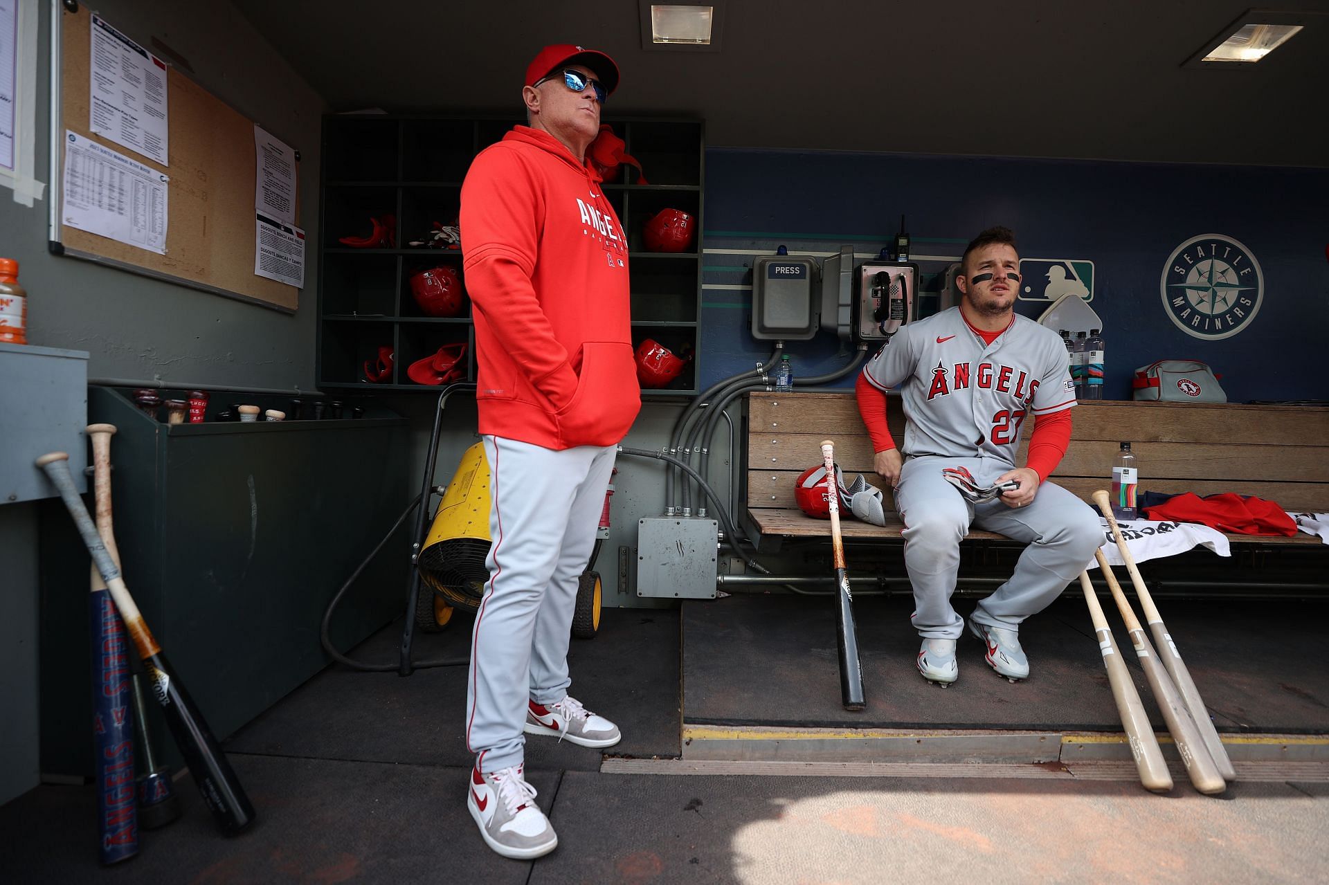 Manager Phil Nevin stands with Mike Trout during the first inning against the Seattle Mariners at T-Mobile Park
