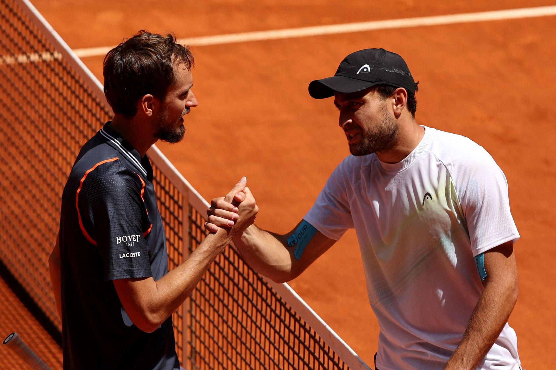 Daniil Medvedev (L) and Aslan Karatsev