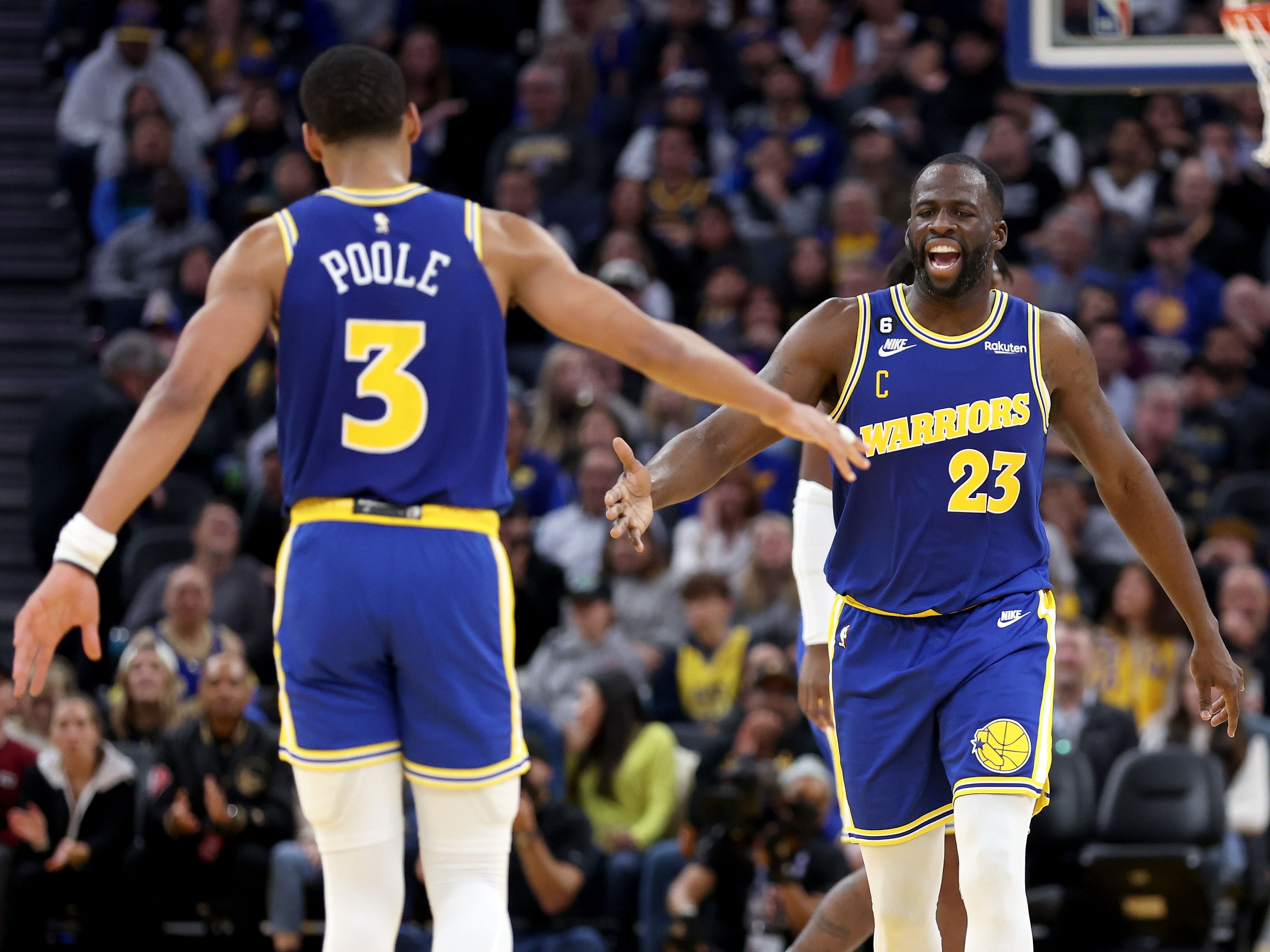 Jordan Poole and Draymond Green of the Golden State Warriors