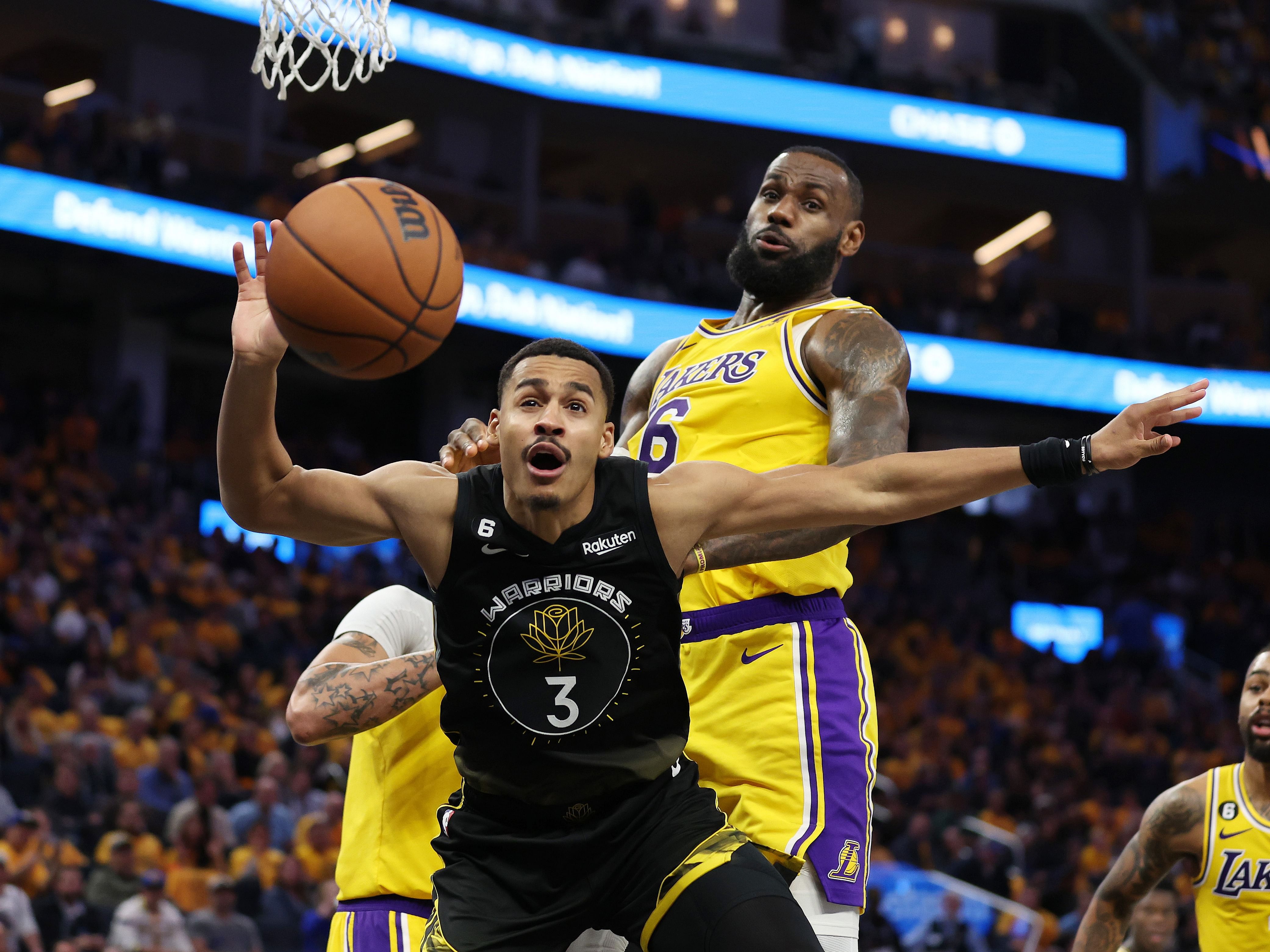 Jordan Poole and LeBron James in action during Lakers vs Warriors Game 1 