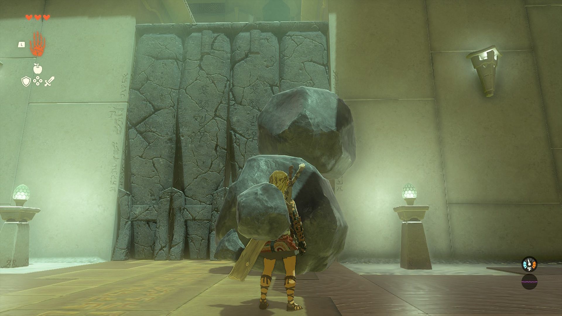 Use the boulders to smash through the wall (Image via Nintendo)