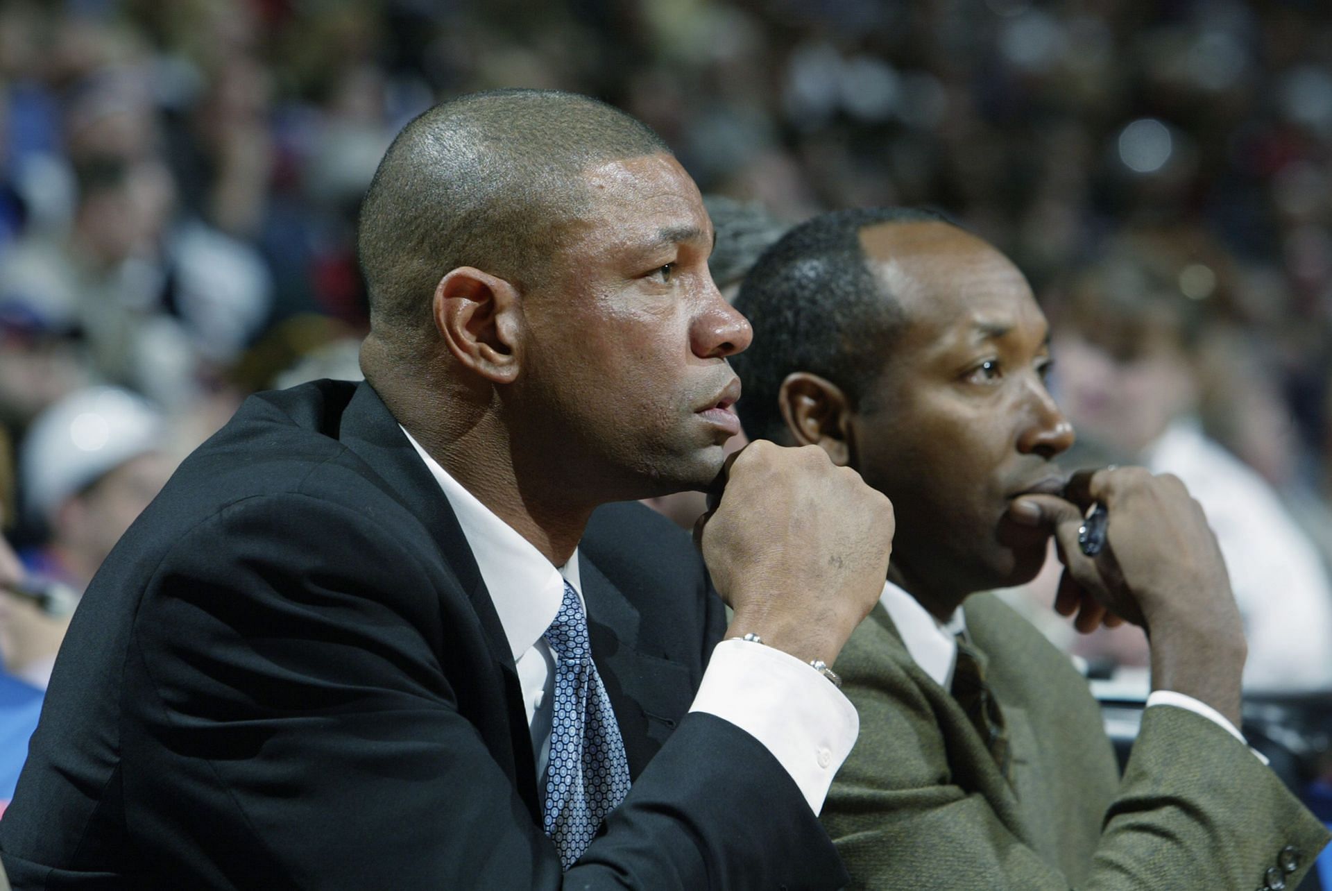 Head coach Doc Rivers and assistant coach Johnny Davis of the Orlando Magic watch from the bench in Game five of the Eastern Conference Quarterfinals against the Detroit Pistons during the 2003 NBA Playoffs 