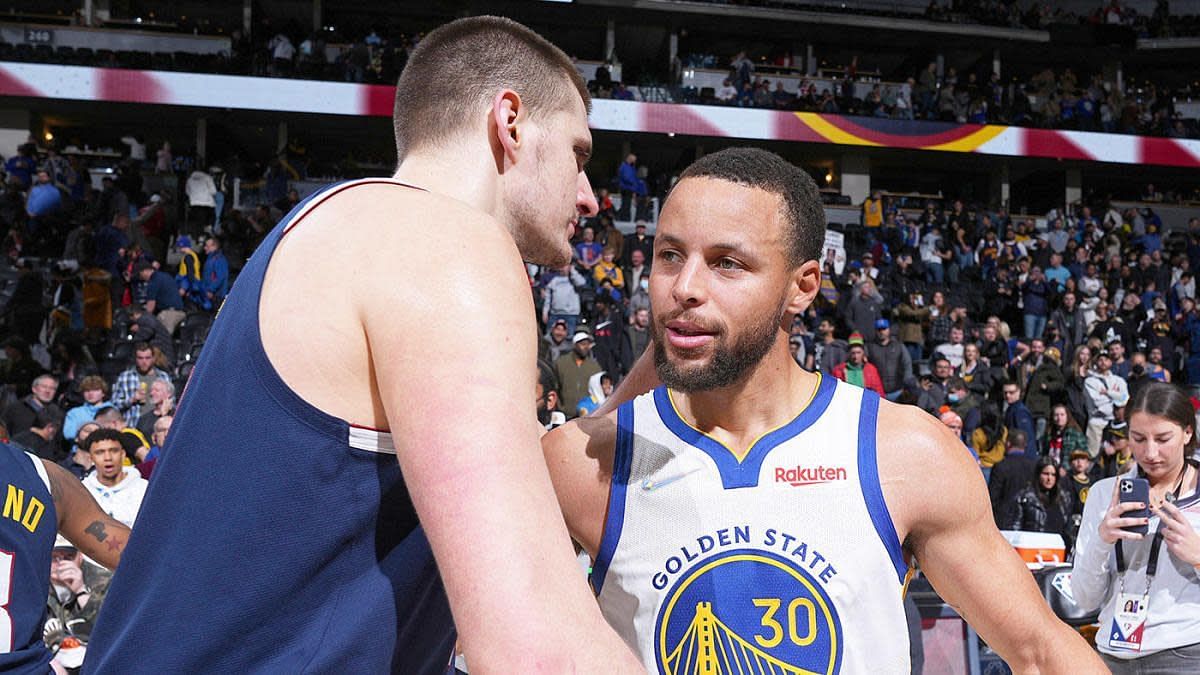 Nikola Jokic of the Denver Nuggets with Stephen Curry of the Golden State Warriors