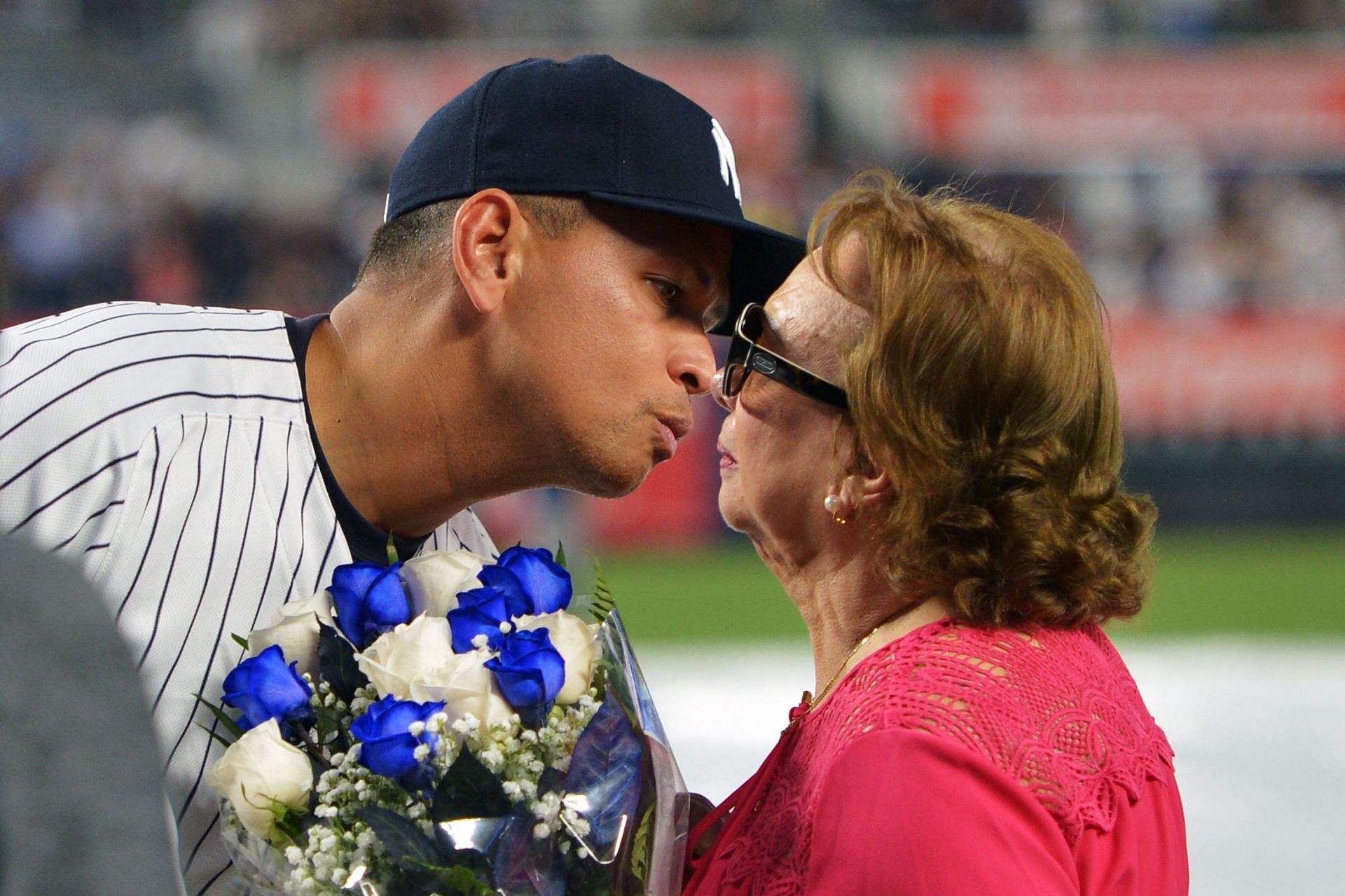 Tampa Bay Rays v New York Yankees: NEW YORK, NY - AUGUST 12: Alex of the New York Yankees kisses his mother, Lourdes Rodriguez, during a presentation in his honor before the game against the Tampa Bay Rays at Yankee Stadium on August 12, 2016, in New York City. (Photo by Drew Hallowell/Getty Images)