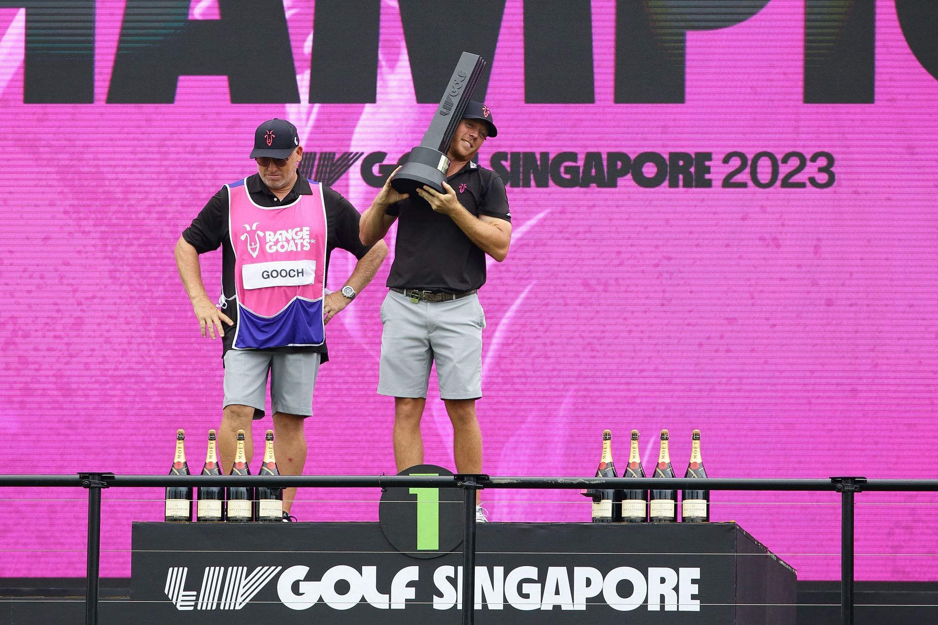 Talor Gooch holding the Champion&acute;s Trophy at the Singapore LIV Golf Invitational (Image via Getty).