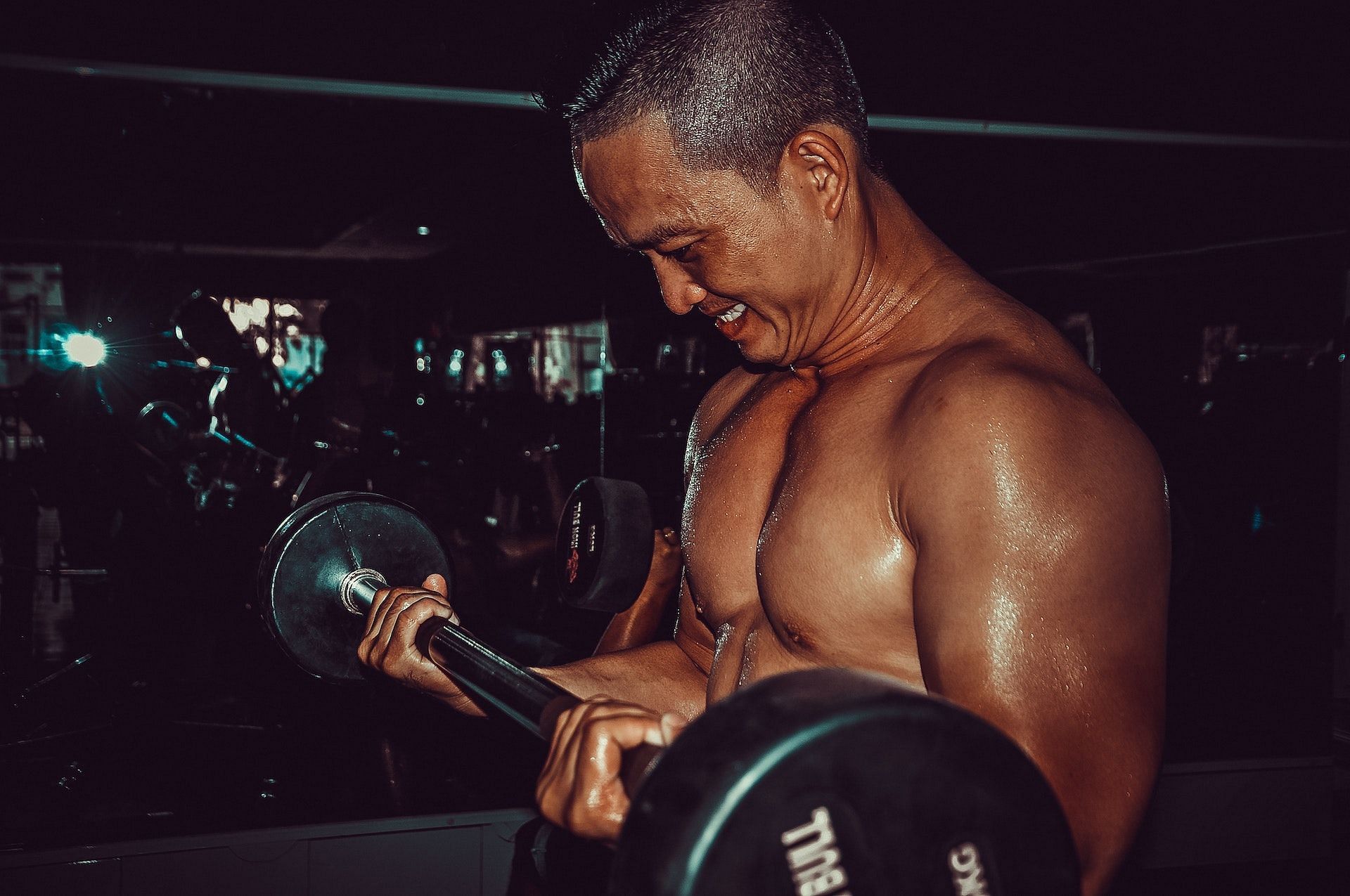 Reverse grip curls target the biceps and forearms. (Photo via Pexels/Tristan Le)