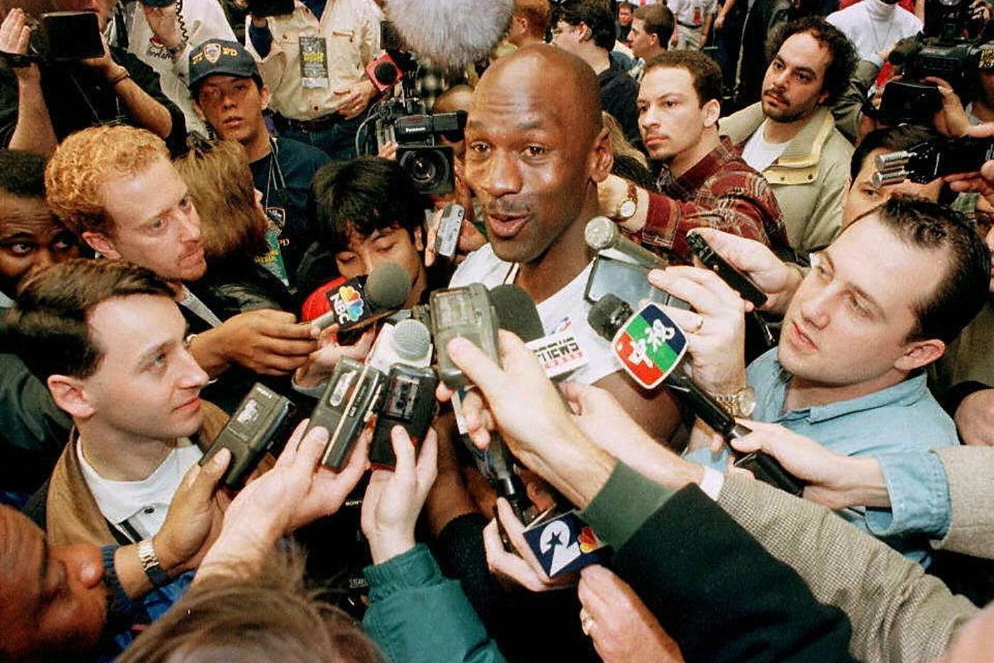 Michael Jordan surrounded by a hoard of media press