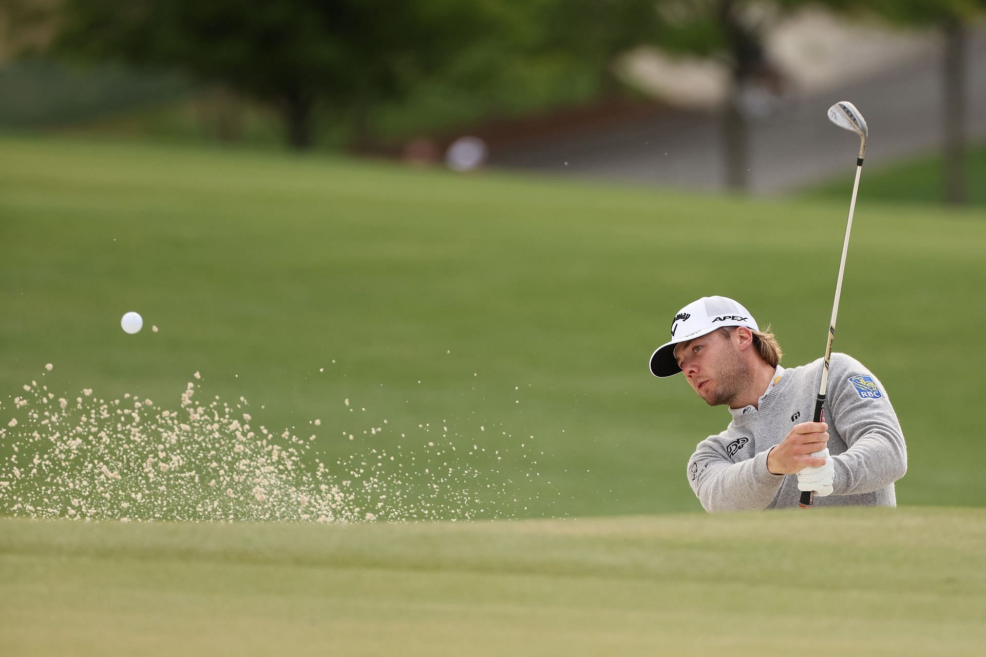 Sam Burns hitting from a bunker during the practice round of the Wells Fargo Championship