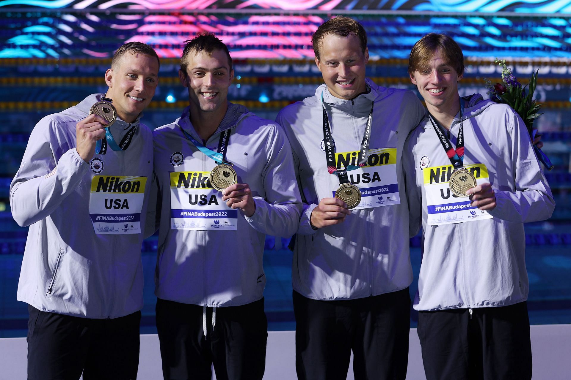 (L-R) Gold medallists Caeleb Dressel, Ryan Held, Justin Ress, and Brooks Curry of Team United States pose for a photo in the medal ceremony for the Men's 4x100m Freestyle Relay Final on day one of the Budapest 2022 FINA World Championships