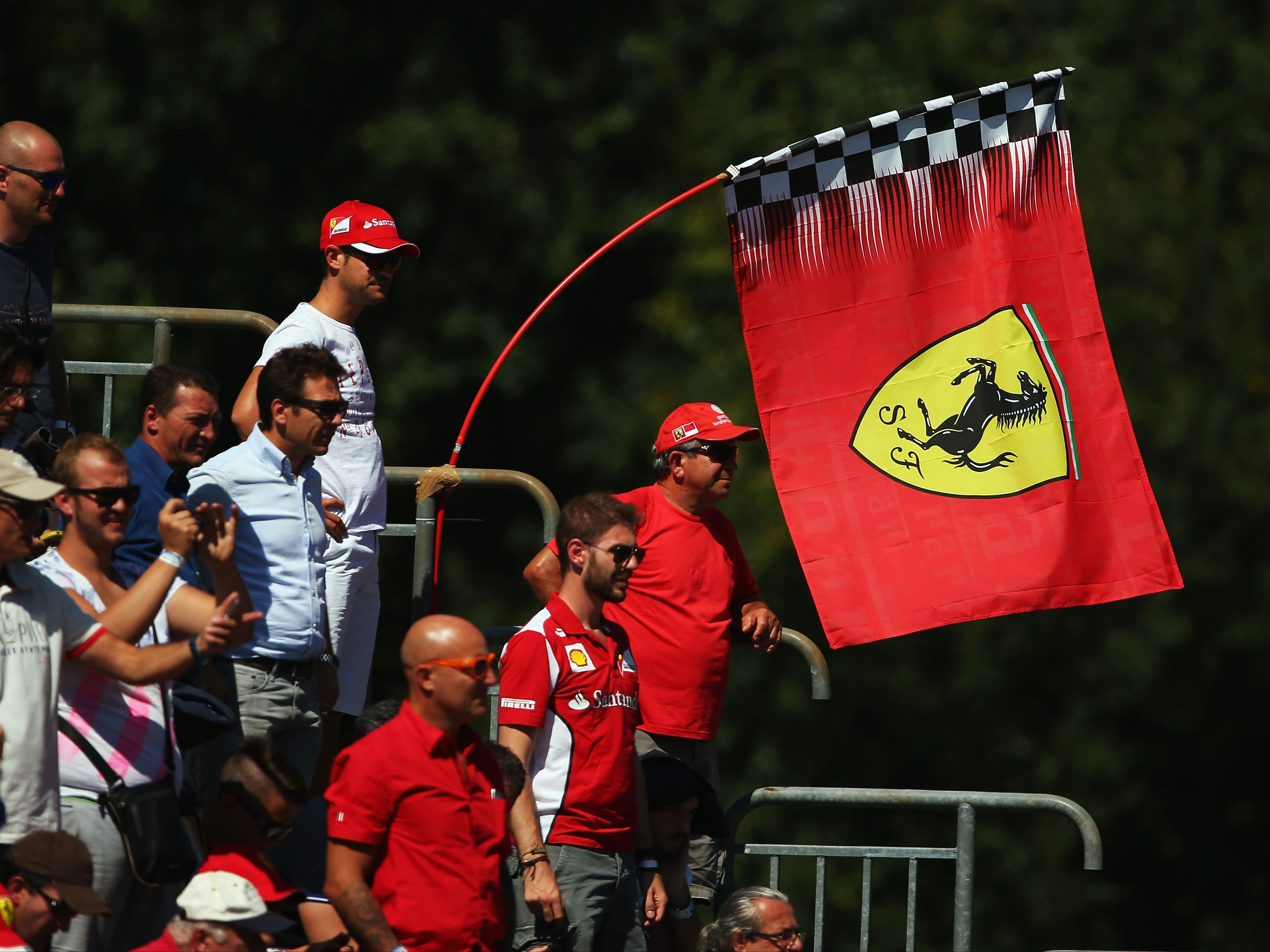 Ferrari fans fly flags in support of their team during the 2015 F1 Italian Grand Prix. (Photo by Bryn Lennon/Getty Images)