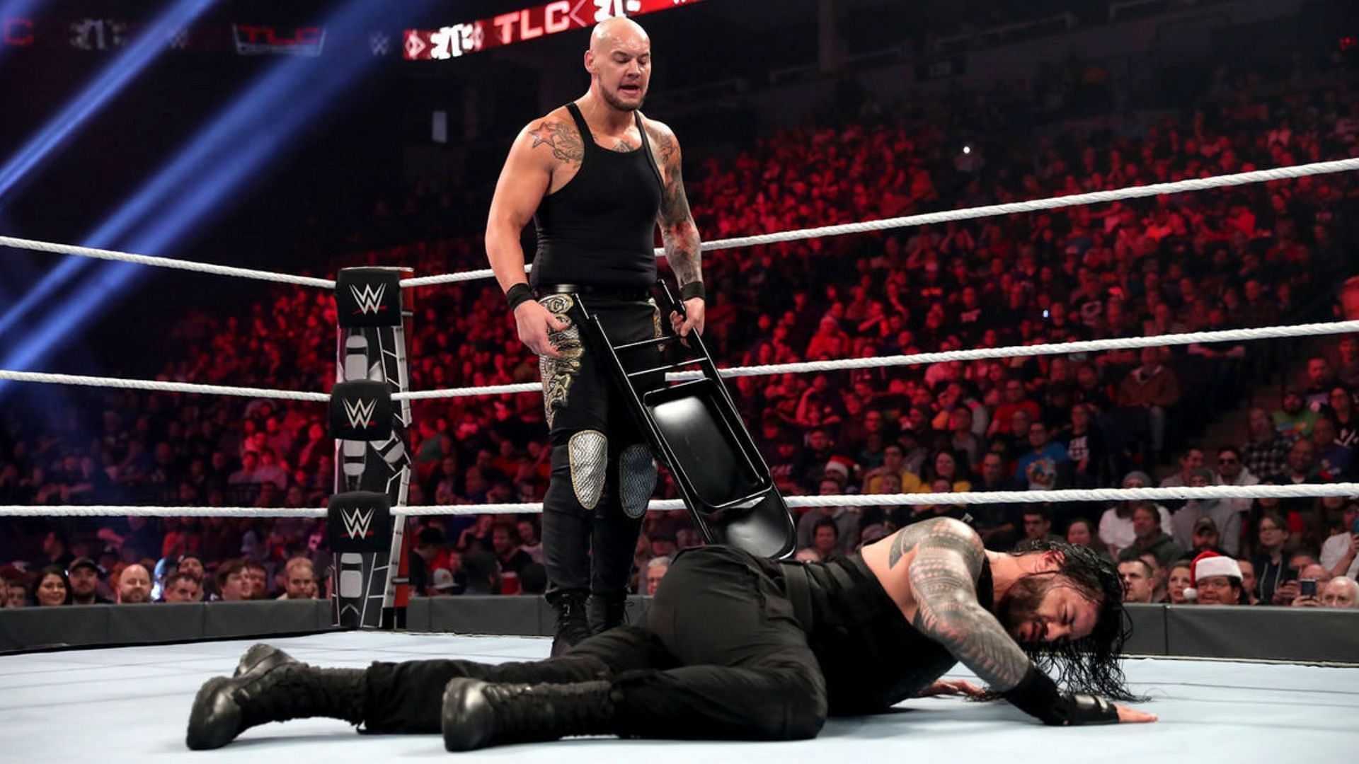 King Corbin wields a steel chair against Roman Reigns at WWE TLC 2019.