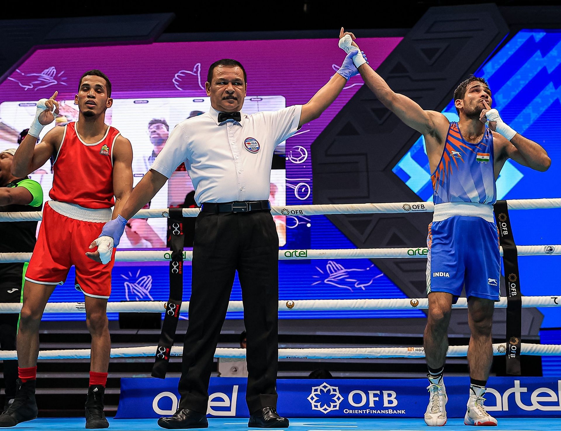 Mohammad Hussamuddin celebrates after winning his quarterfinal bout at the 2023 World Boxing Championship.