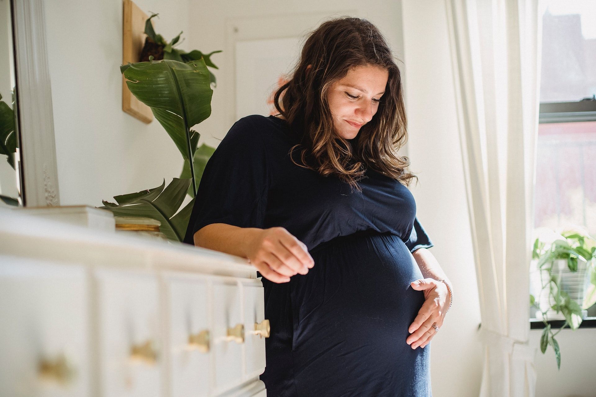 Pregnancy is one of the most likely causes of periods getting shorter and lighter. (Photo via Pexels/Amina Filkins)