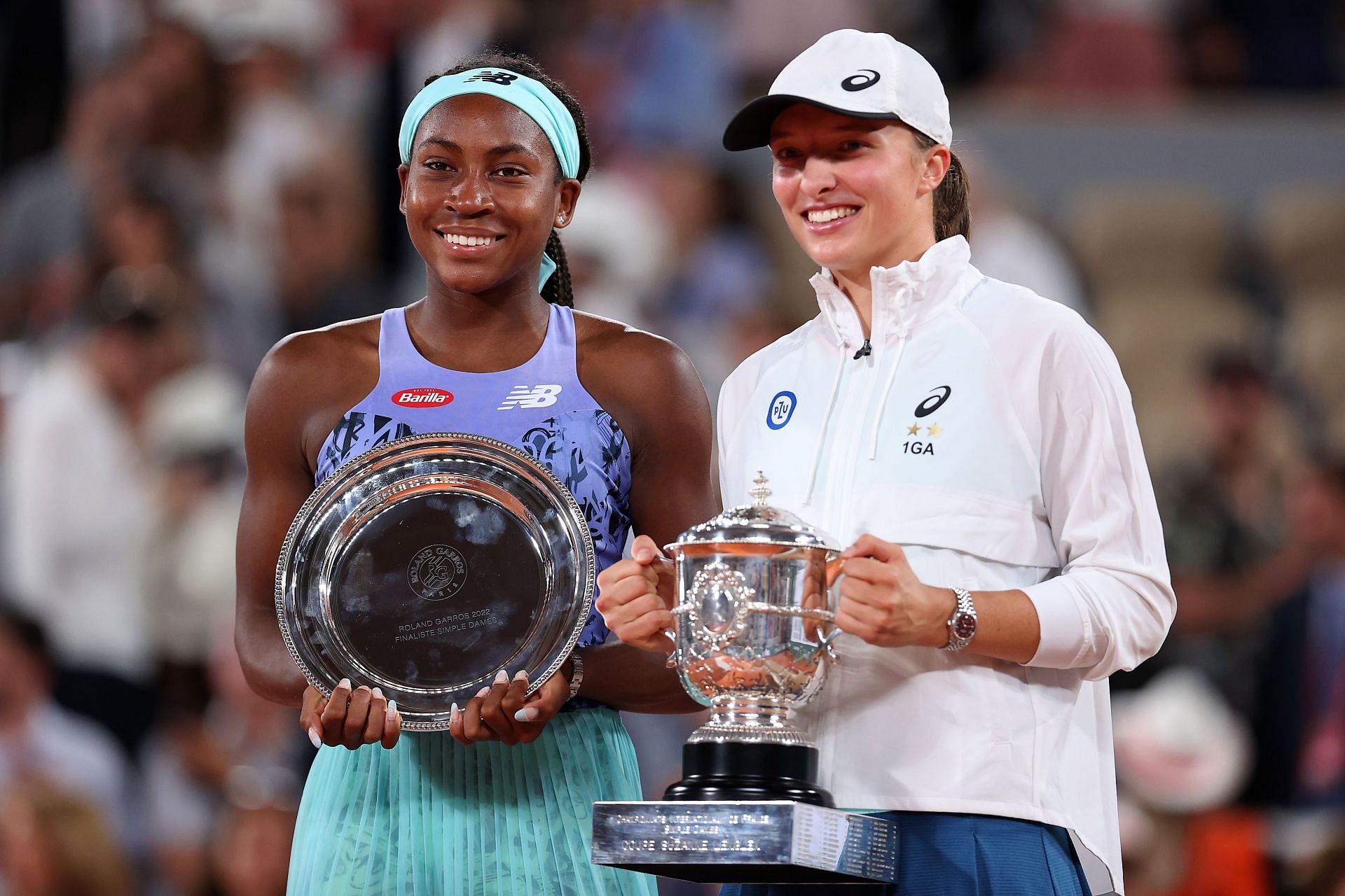 2022 French Open - Day Fourteen Iga Swiatek of Poland (R) poses with the winner&#039;s trophy as Coco Gauff of The United States poses with the runners-up trophy after their Women&#039;s Singles final match of The 2022 French Open