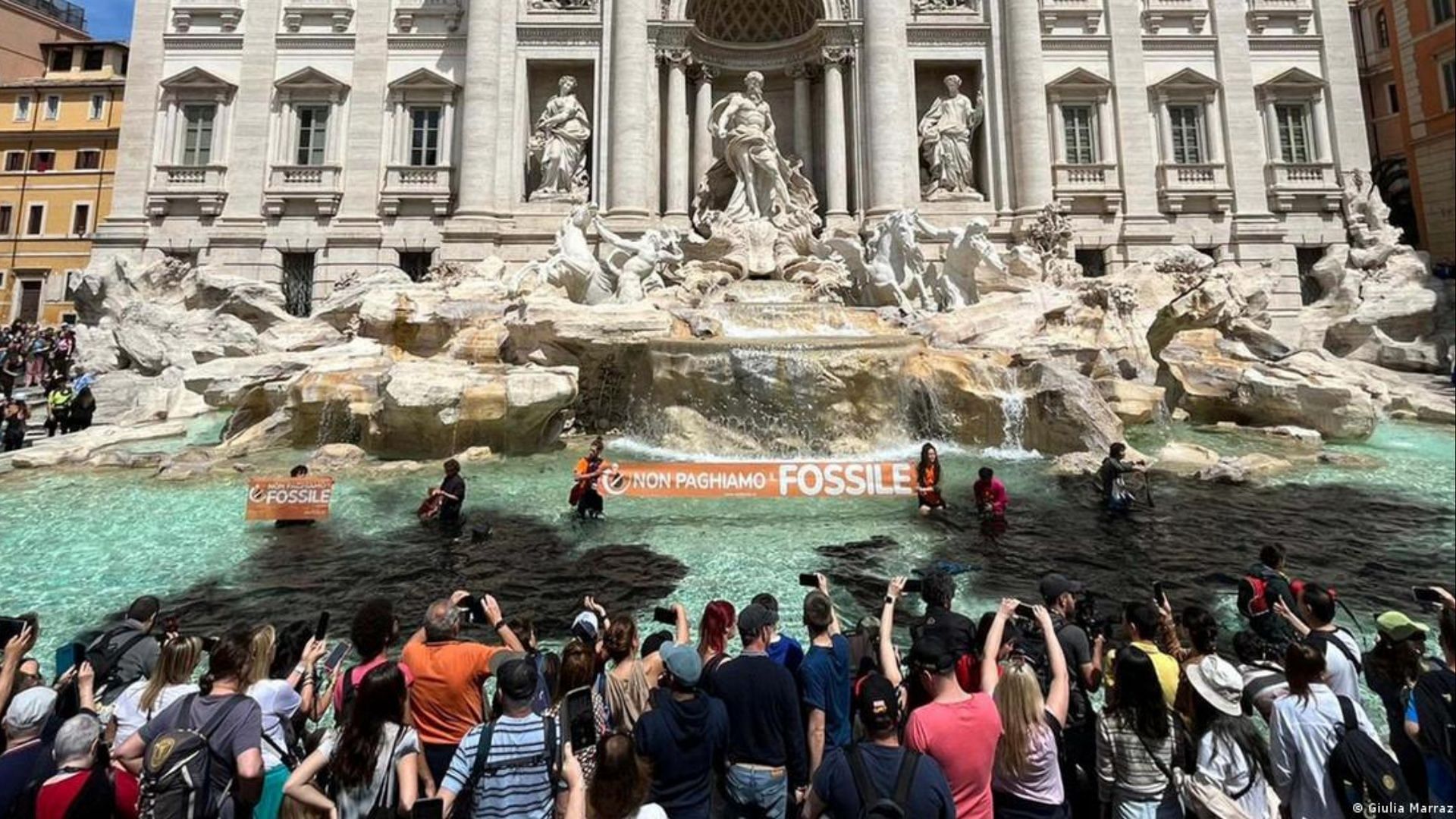 Climate activists pour diluted charcoal into the waters in Rome