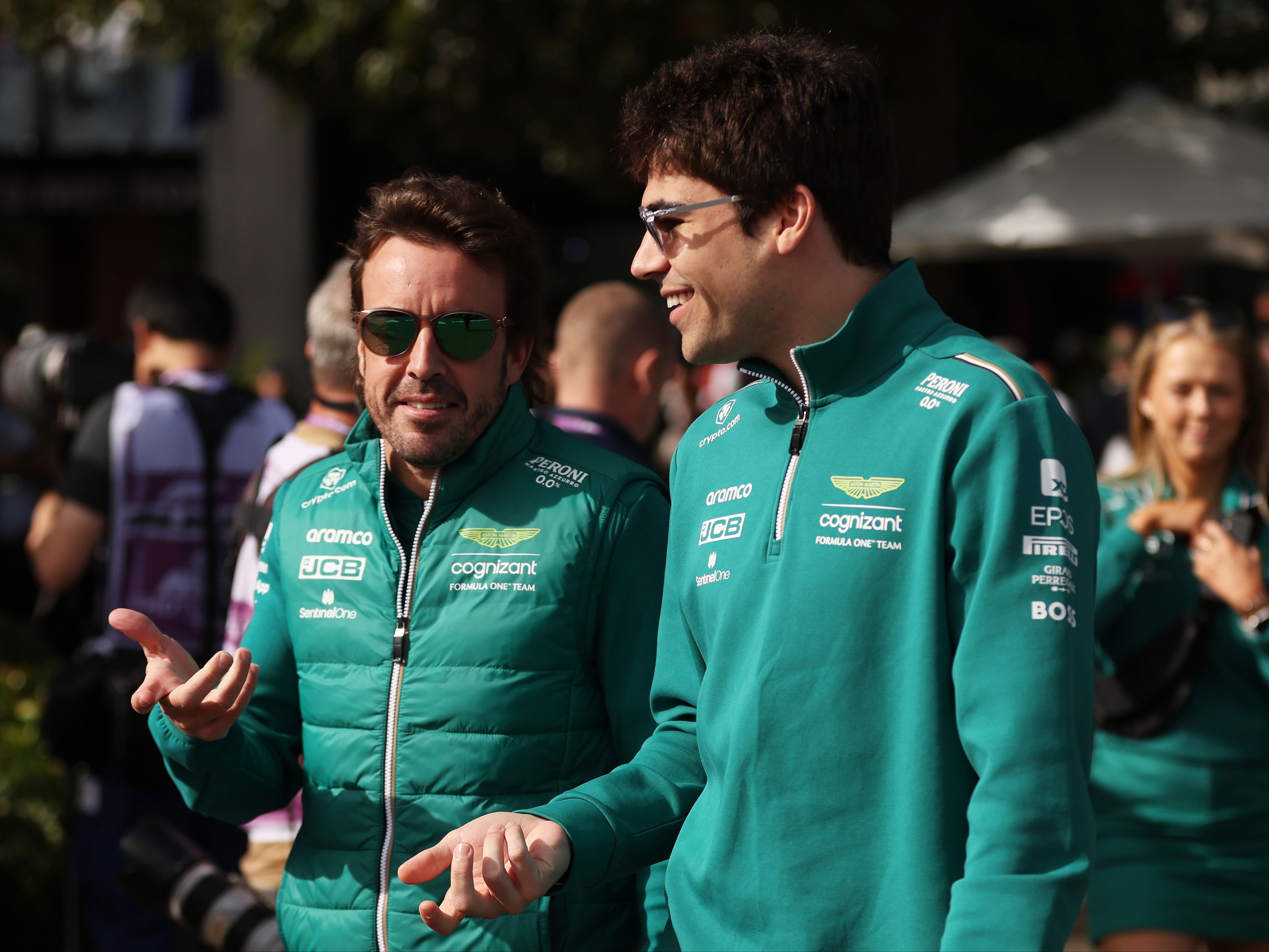 Fernando Alonso and Lance Stroll talk in the paddock prior to during practice ahead of the 2023 F1 Australian Grand Prix. (Photo by Robert Cianflone/Getty Images)