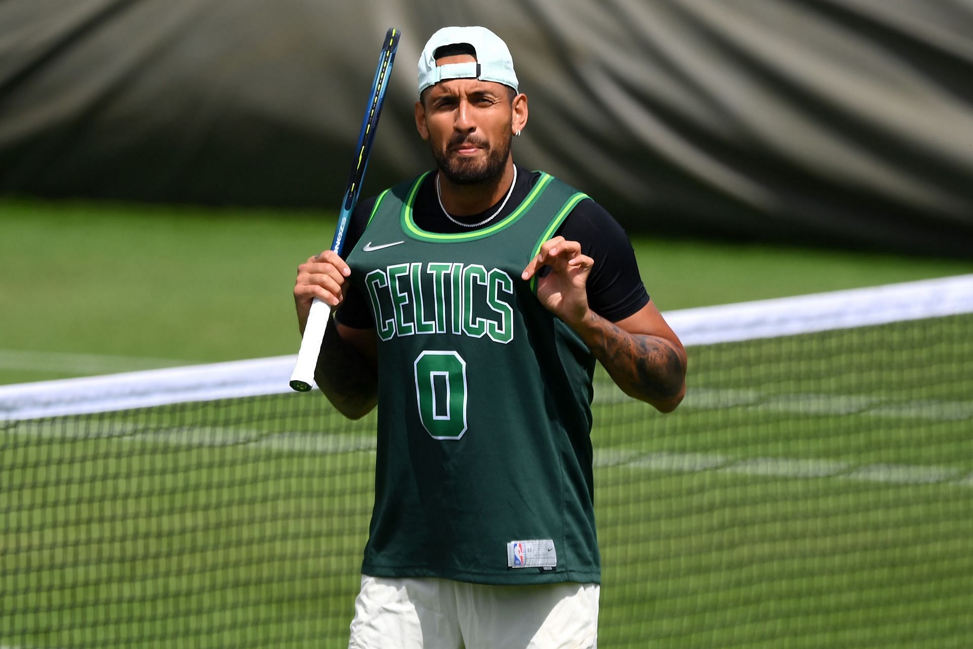 Nick Kyrgios wearing a Boston Celtics jersey during a practice session at the Wimbledon in 2022.