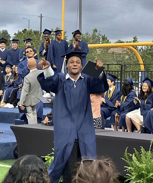 Bronny pointing at his family after getting the diploma Enter caption