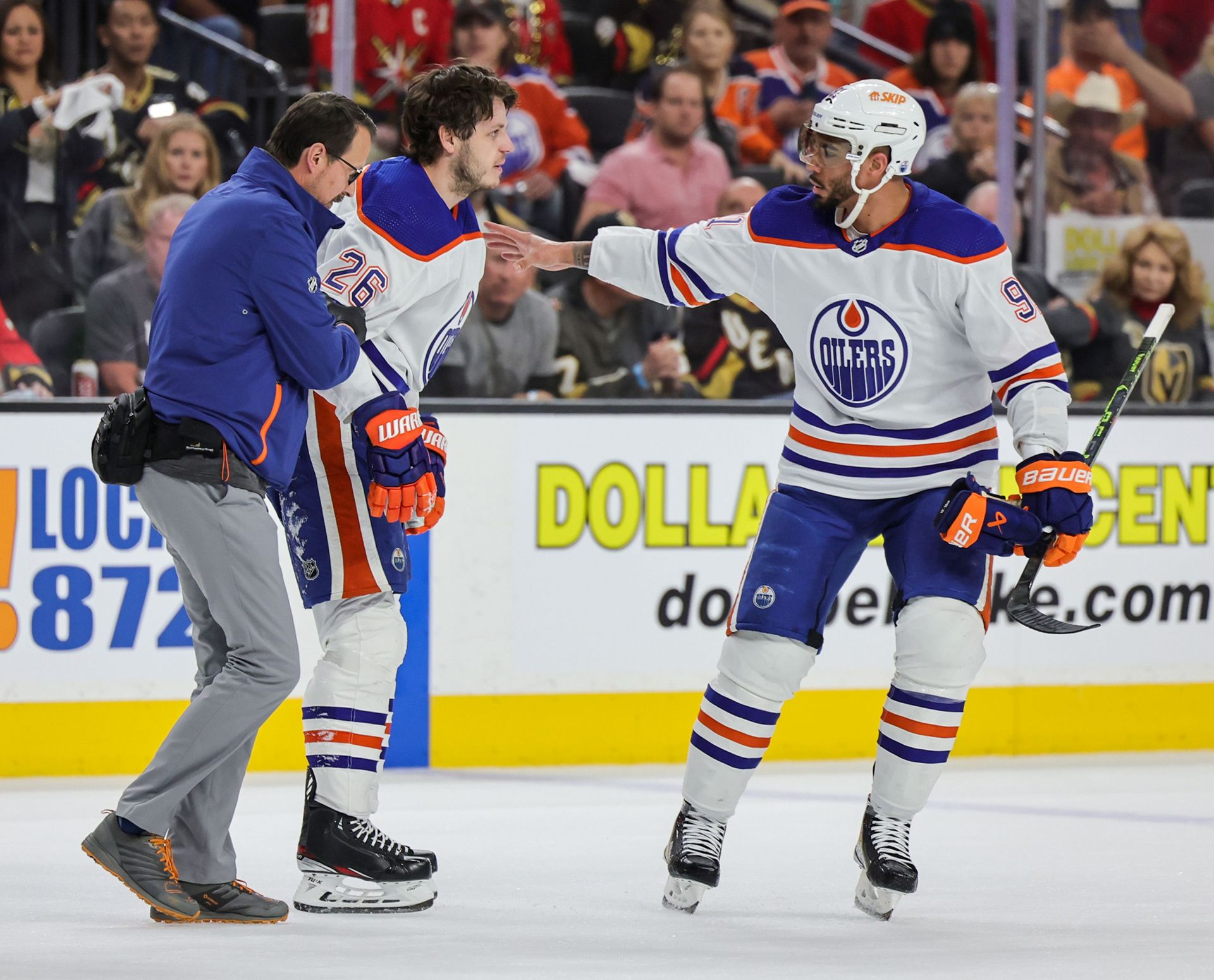 Mattias Janmark #26 of the Edmonton Oilers is helped off the ice by a trainer and teammate Evander Kane #91 after Janmark was injured in the first period of Game One of the Second Round of the 2023 Stanley Cup Playoffs against the Vegas Golden Knights at T-Mobile Arena on May 03, 2023 in Las Vegas, Nevada. The Golden Knights defeated the Oilers 6-4. (Photo by Ethan Miller/Getty Images)