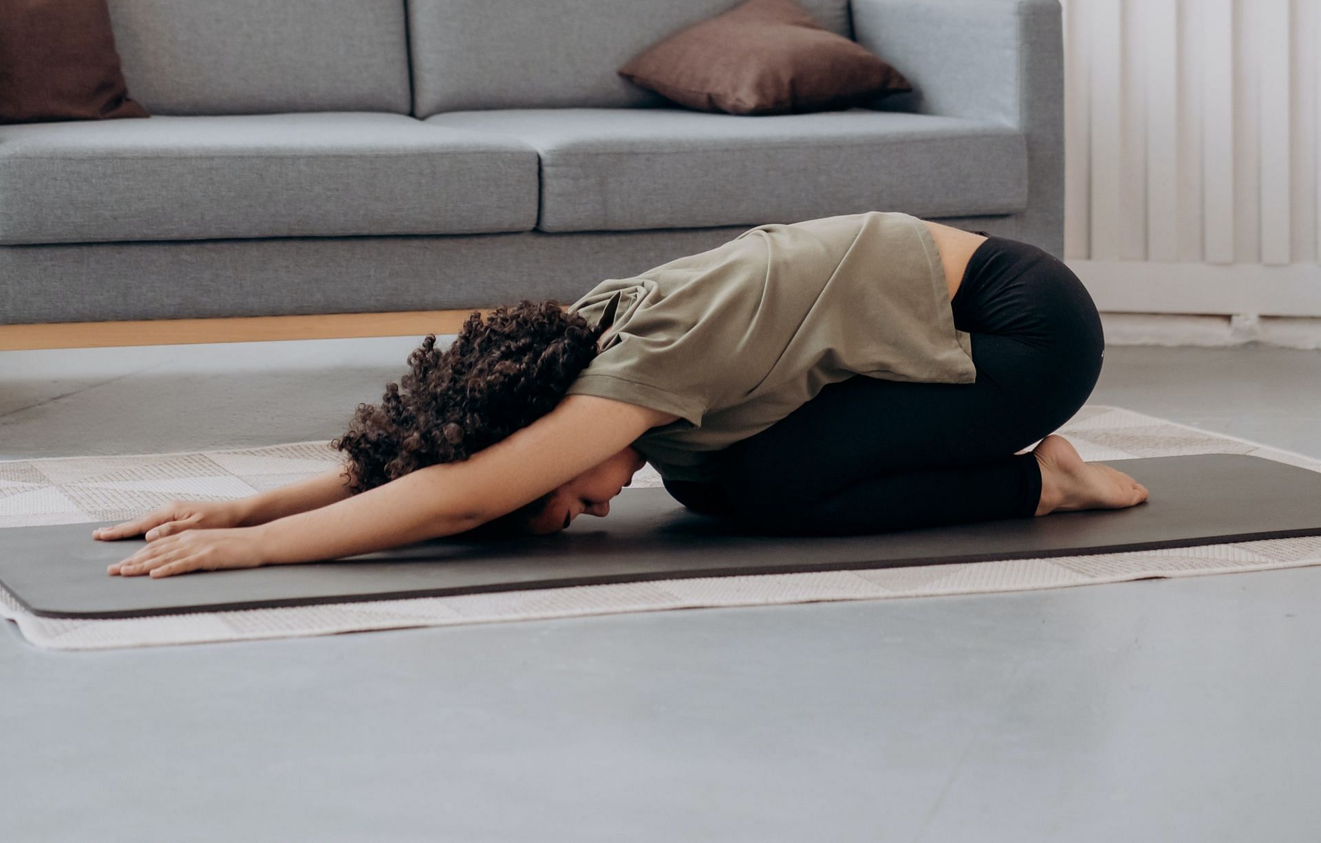 Child&#039;s pose, a gentle yoga pose, can aid in releasing tension in the pelvic floor. (Mikhail Nilov/Pexels)