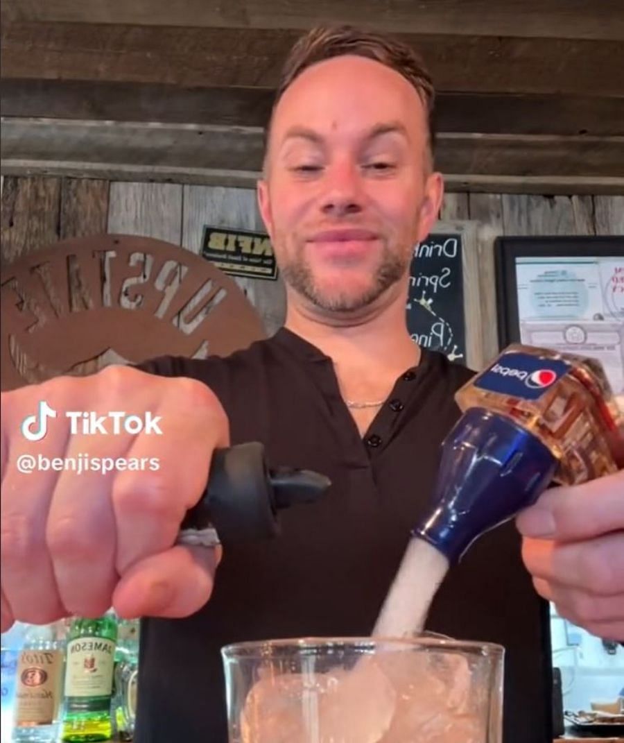 In the video, Benji can be seen holding a bottle of spirit while actually filling the glass with his Soda spray (Image via TikTok/@benjispears)