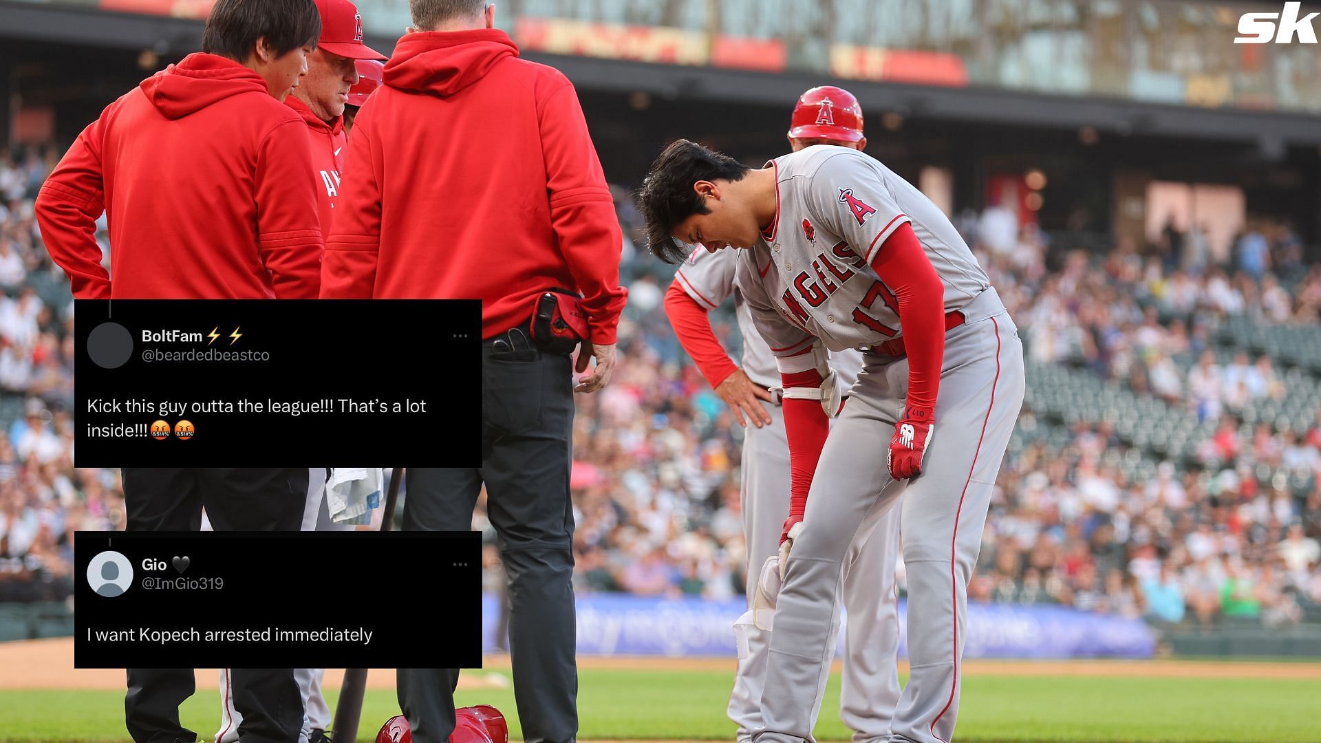 Shohei Ohtani of the Los Angeles Angels is looked over by trainers after being hit by a pitch from Michael Kopech of the Chicago White Sox
