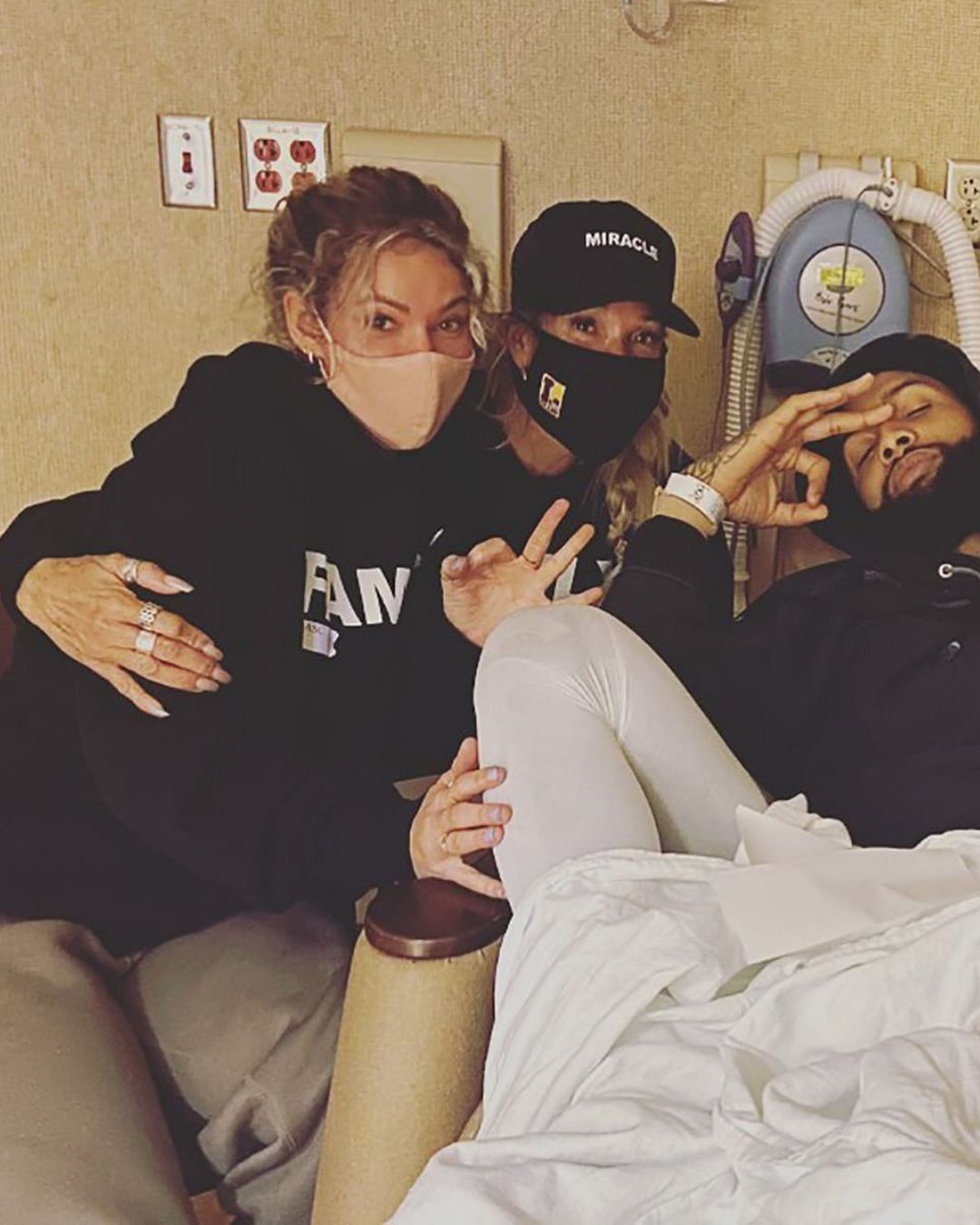 Wood and a friend with Beckham Jr. after his surgery. Credit: Heather Van Norman (IG)
