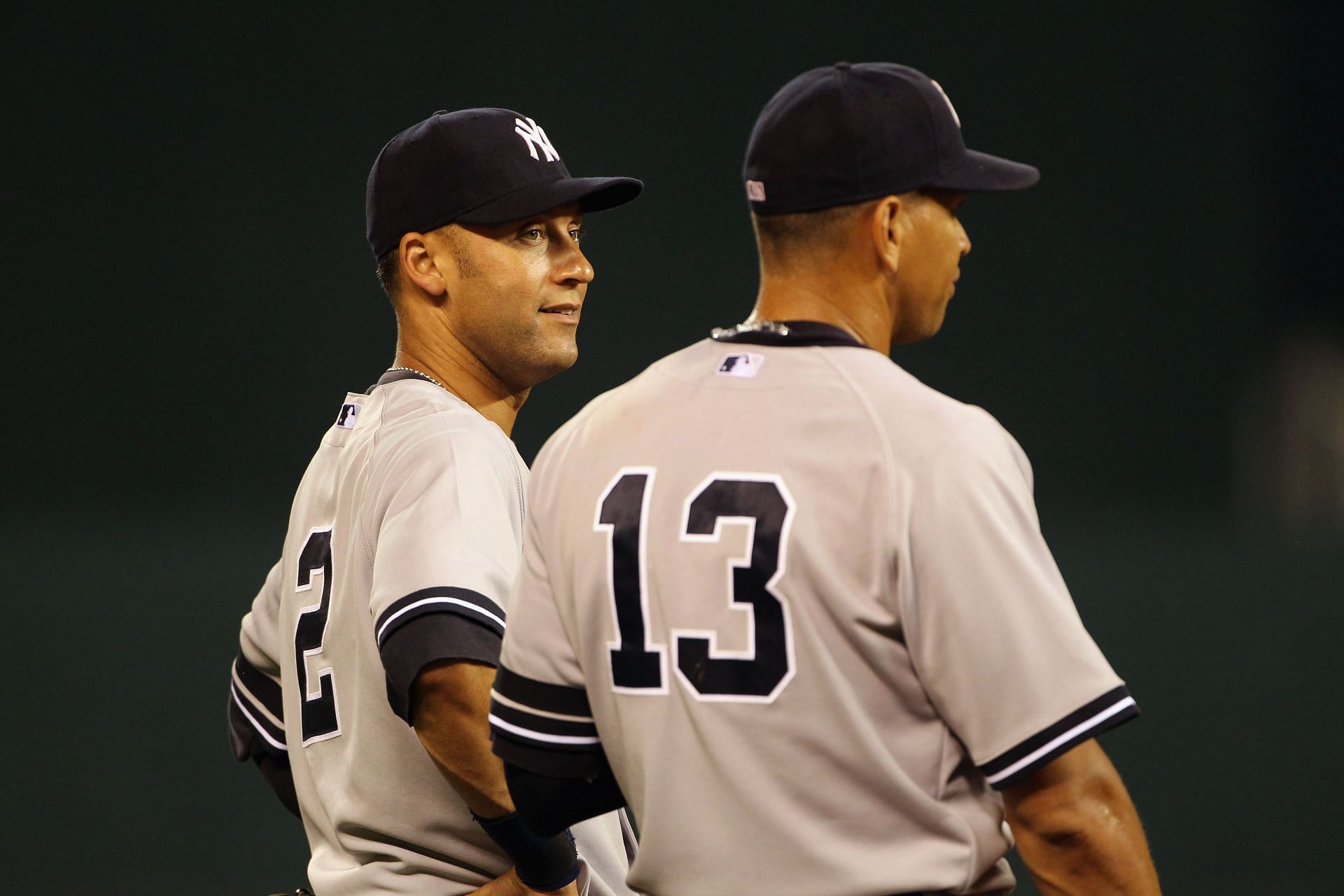 Derek Jeter #2 and Alex Rodriguez #13 of the New York Yankees chat while warming up prior to the 5th inning of the game against the Kansas City Royals on August 13, 2010 at Kauffman Stadium in Kansas City, Missouri.
