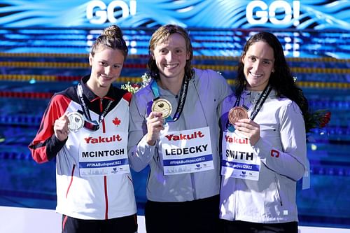 Silver medalist Summer McIntosh of Team Canada, Gold medalist Katie Ledecky of Team United States, and Bronze medallist Leah Smith of Team United States celebrate in the medal ceremony for the Women's 400m Freestyle Final on day one of the Budapest 2022 FINA World Championships