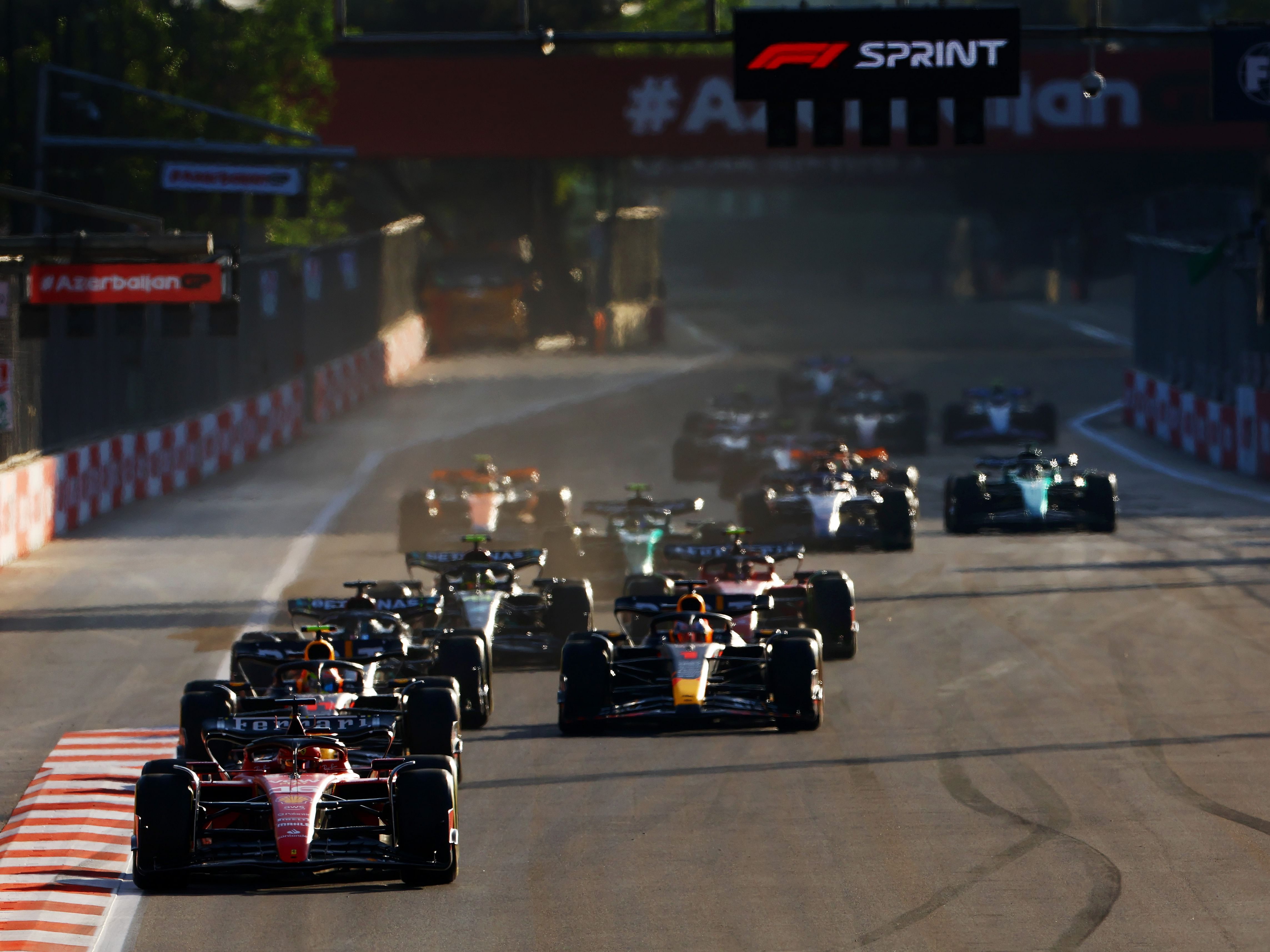 Charles Leclerc (16) leads Sergio Perez (11) and the rest of the field at the start during the Sprint ahead of the 2023 F1 Azerbaijan Grand Prix. (Photo by Mark Thompson/Getty Images)