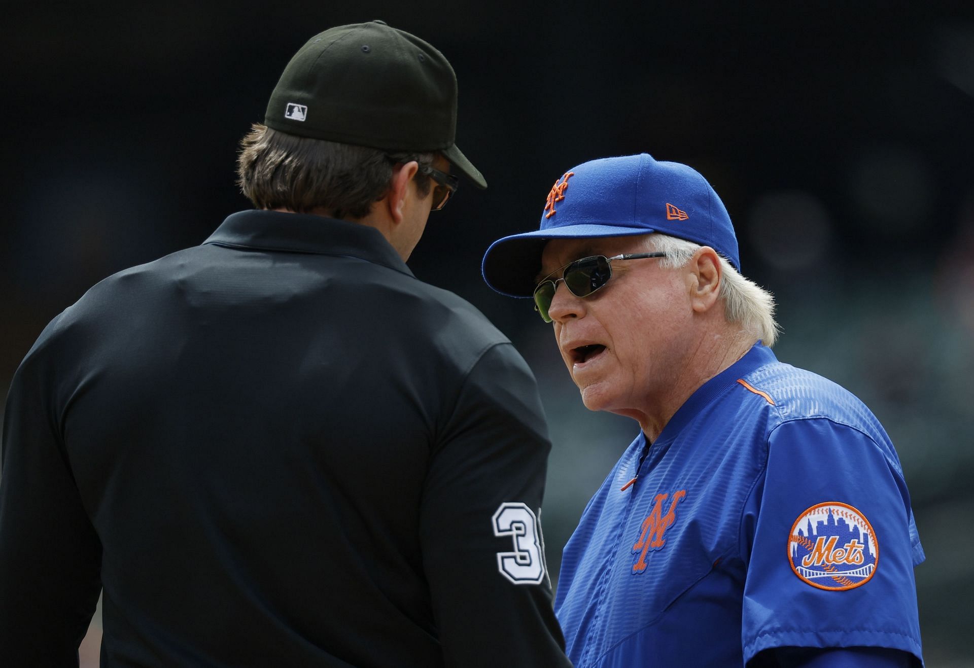 Manager Buck Showalter talks with home plate umpire Adam Beck during a game against the Detroit Tigers at Comerica Park