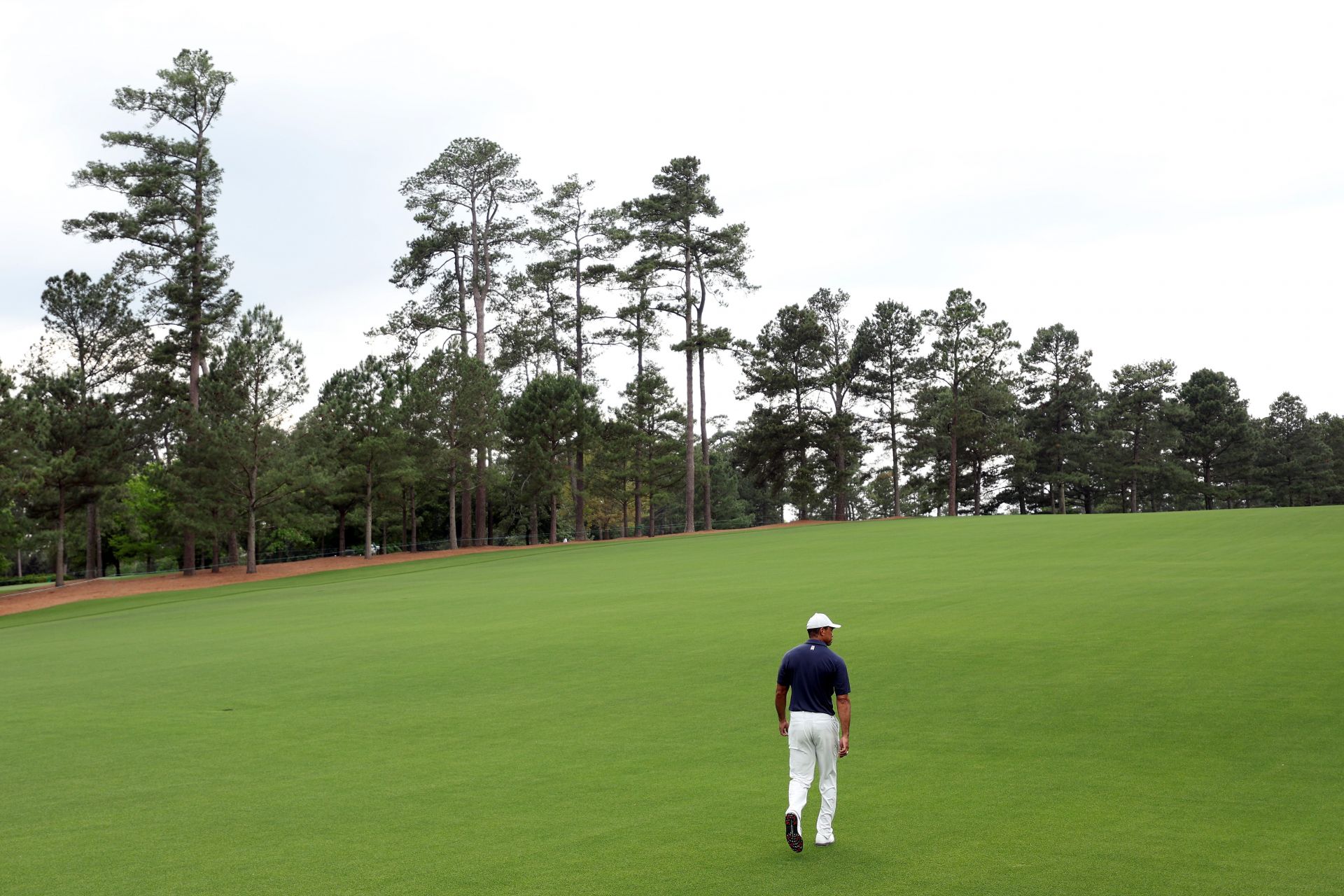 Tiger Woods walking on the Augusta National Golf Club course, home of The Masters Tournament. (Image via Getty).