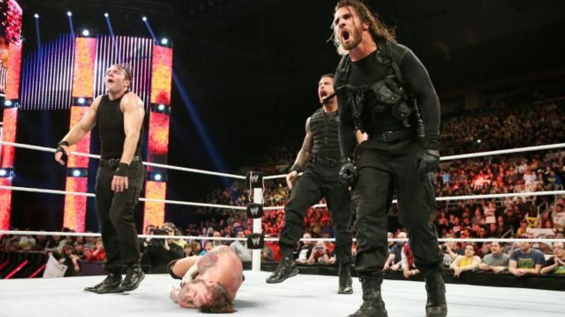 The Shield pose after destroying CM Punk at a WWE show.