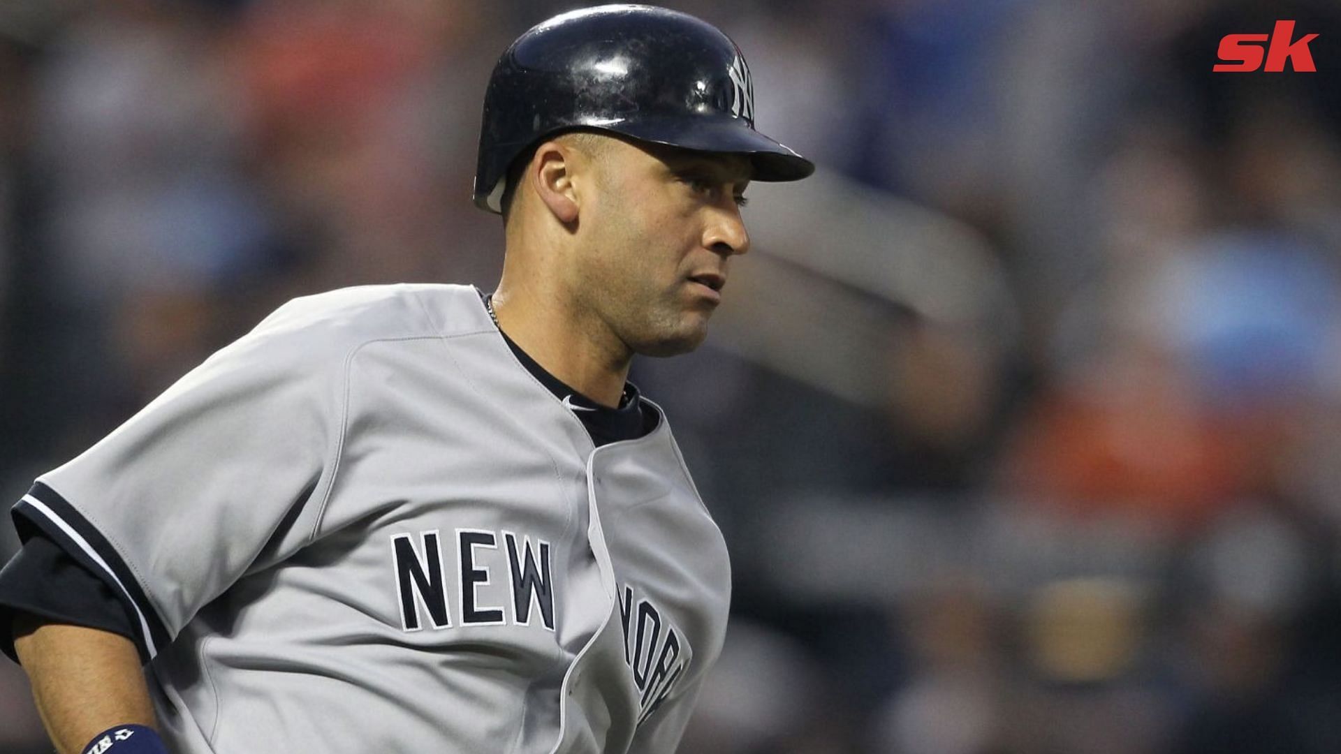 American League's Derek Jeter (L) talks with teammate Miguel