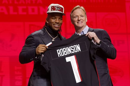 Bijan Robinson poses with NFL Commissioner Roger Goodell after being selected by the Atlanta Falcons