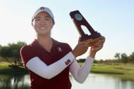 Rose Zhang posing with the NCAA Women’s Golf Division One Championships trophy