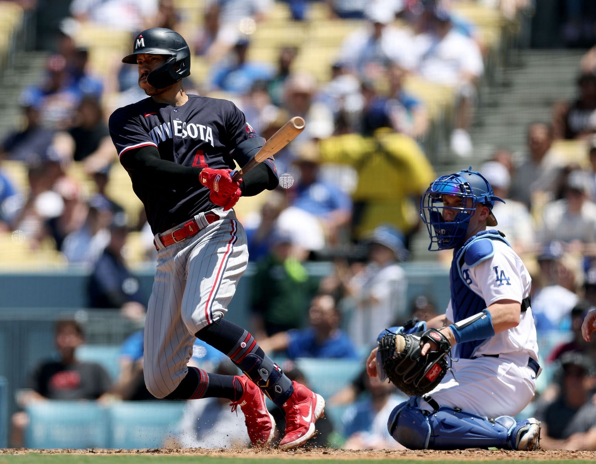 Carlos Correa of the Minnesota Twins bats in front of Will Smith of the Los Angeles Dodgers.