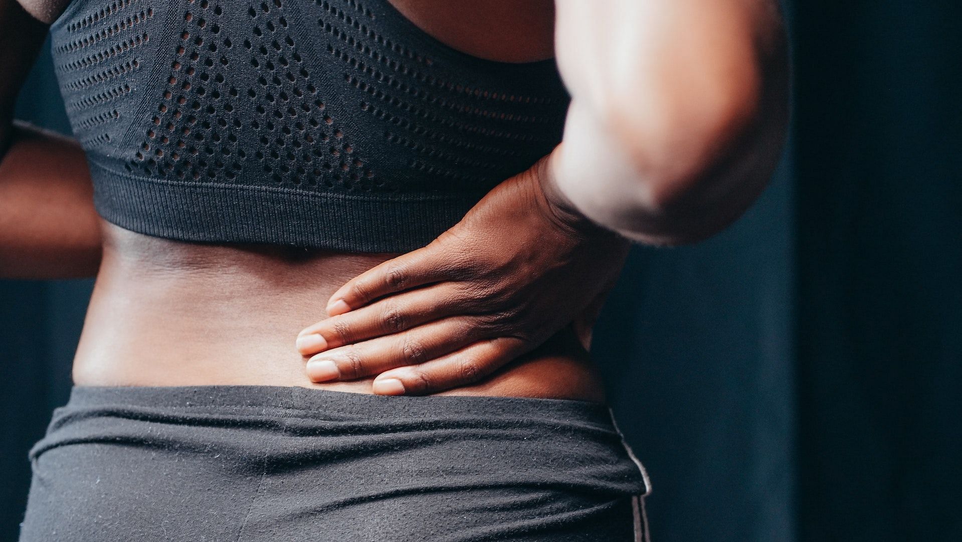Hip pain can extend to lower back muscles. (Photo via Pexels/Kindel Media)