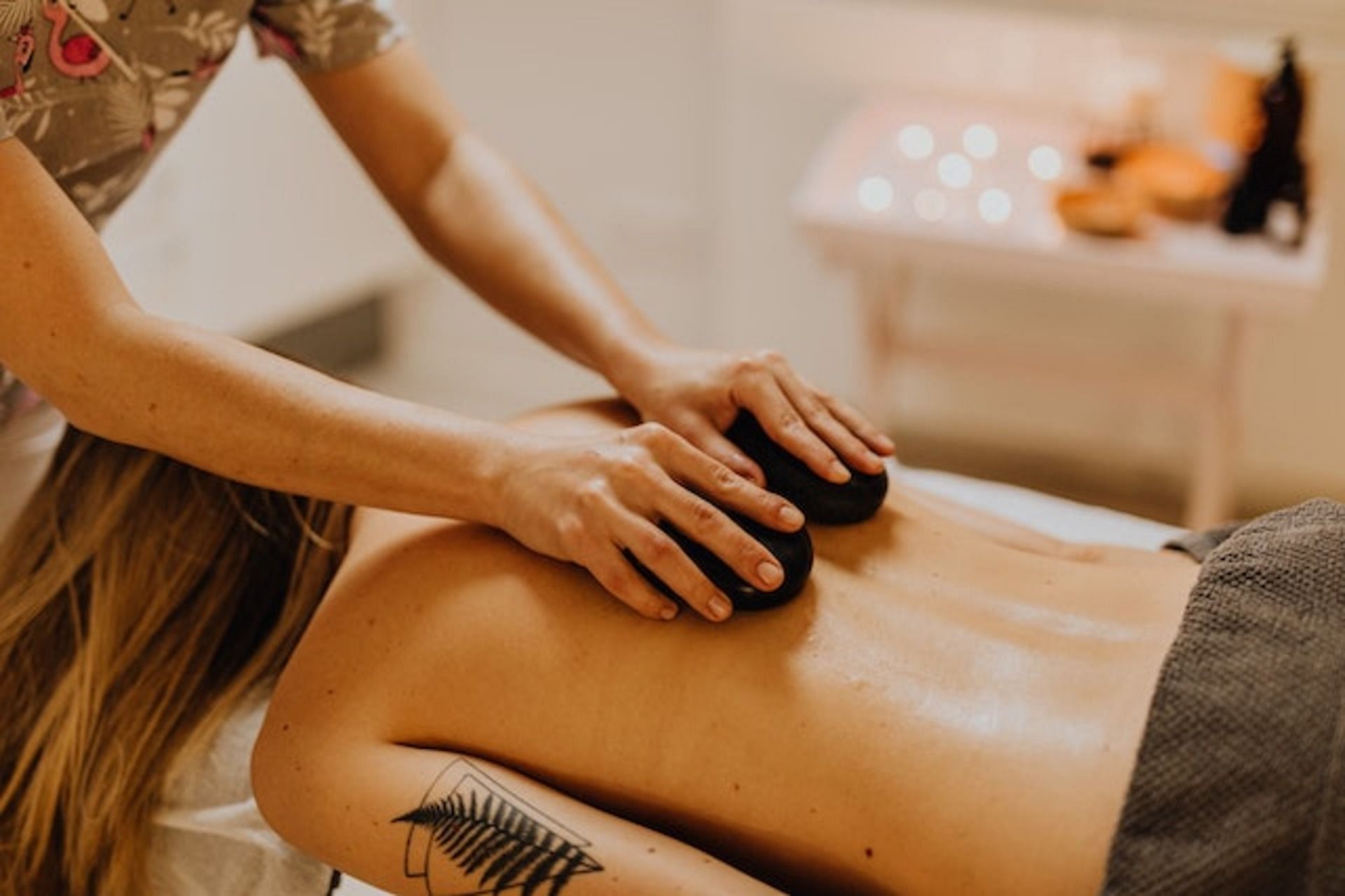 Hot stone therapy. (Image via Pexels/ Karolina Grabowska)