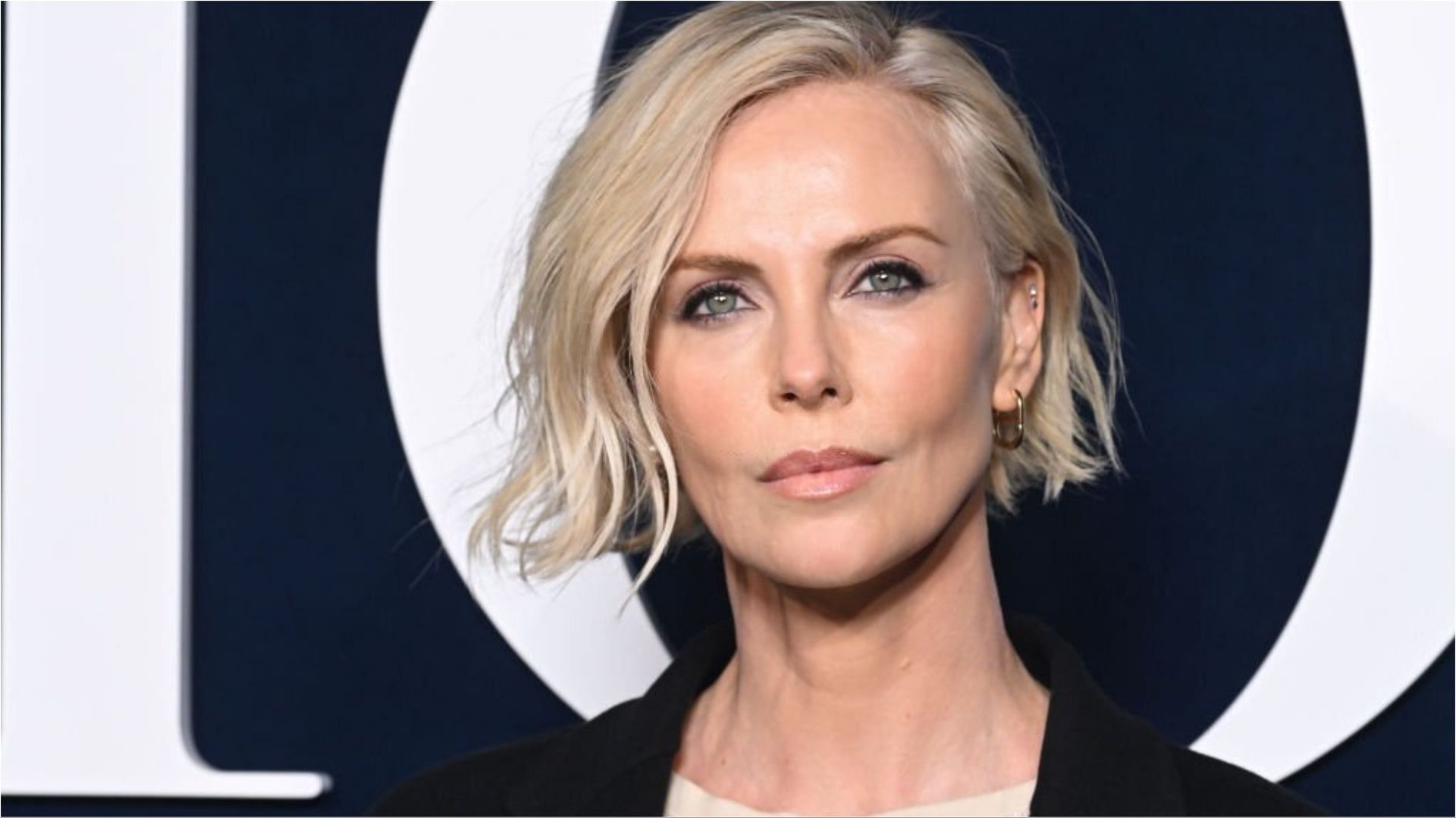 Charlize Theron said that she loves herself (Image via Stephane Cardinale/Getty Images)