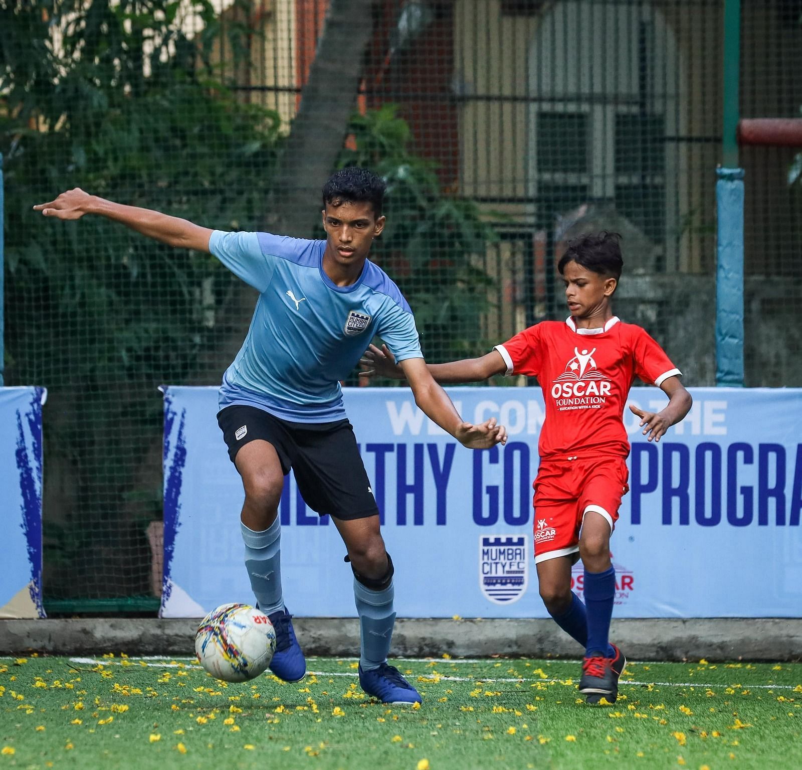 Mumbai City FC players inspiring young athletes during a 'Healthy Goals' football session.