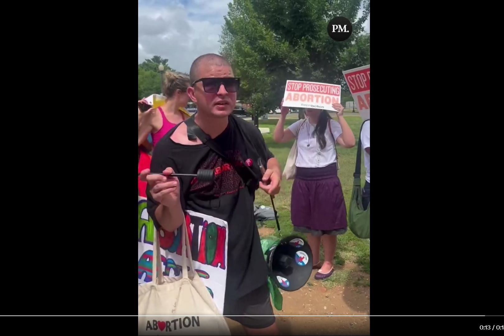 A video that has gained significant attention features a protester making a bold assertion that men possess the ability to have abortions. (Image via Twitter/ The Post Millennial)
