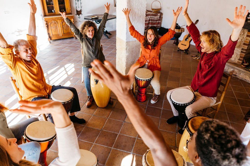 Cheerful friends in music therapy(Image via Getty Images)